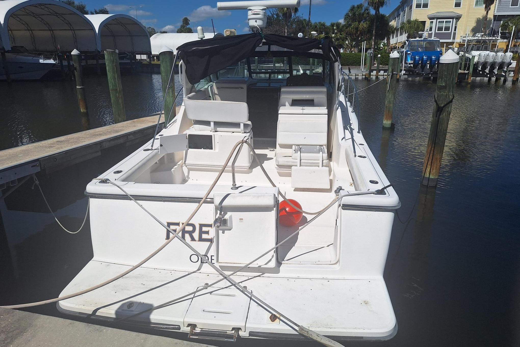 2002 Tiara Yachts 3500 Open docked at marina, rear view.