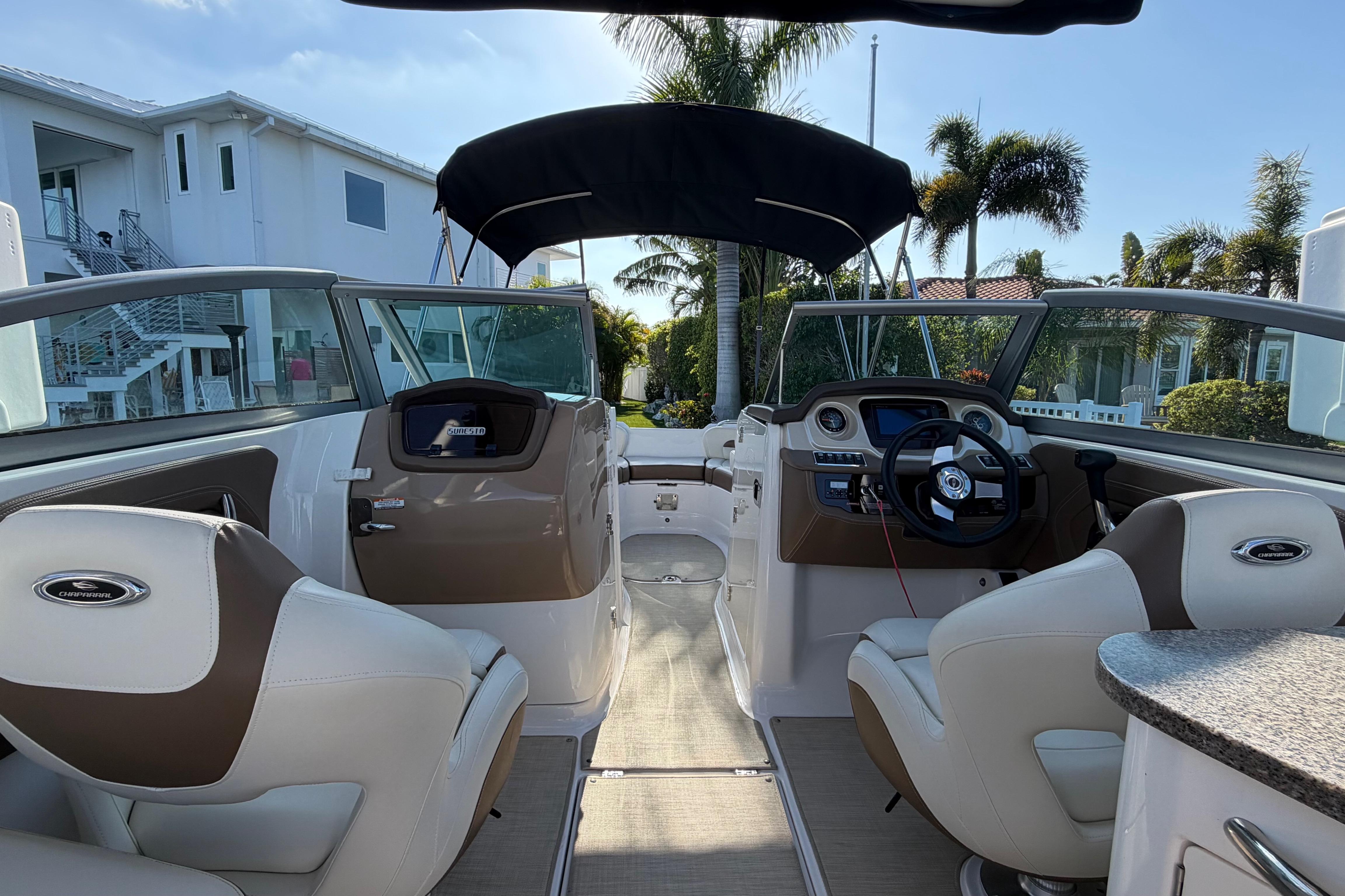 Interior view of 2015 Chaparrall 264 Sunesta boat with modern dashboard and seating.