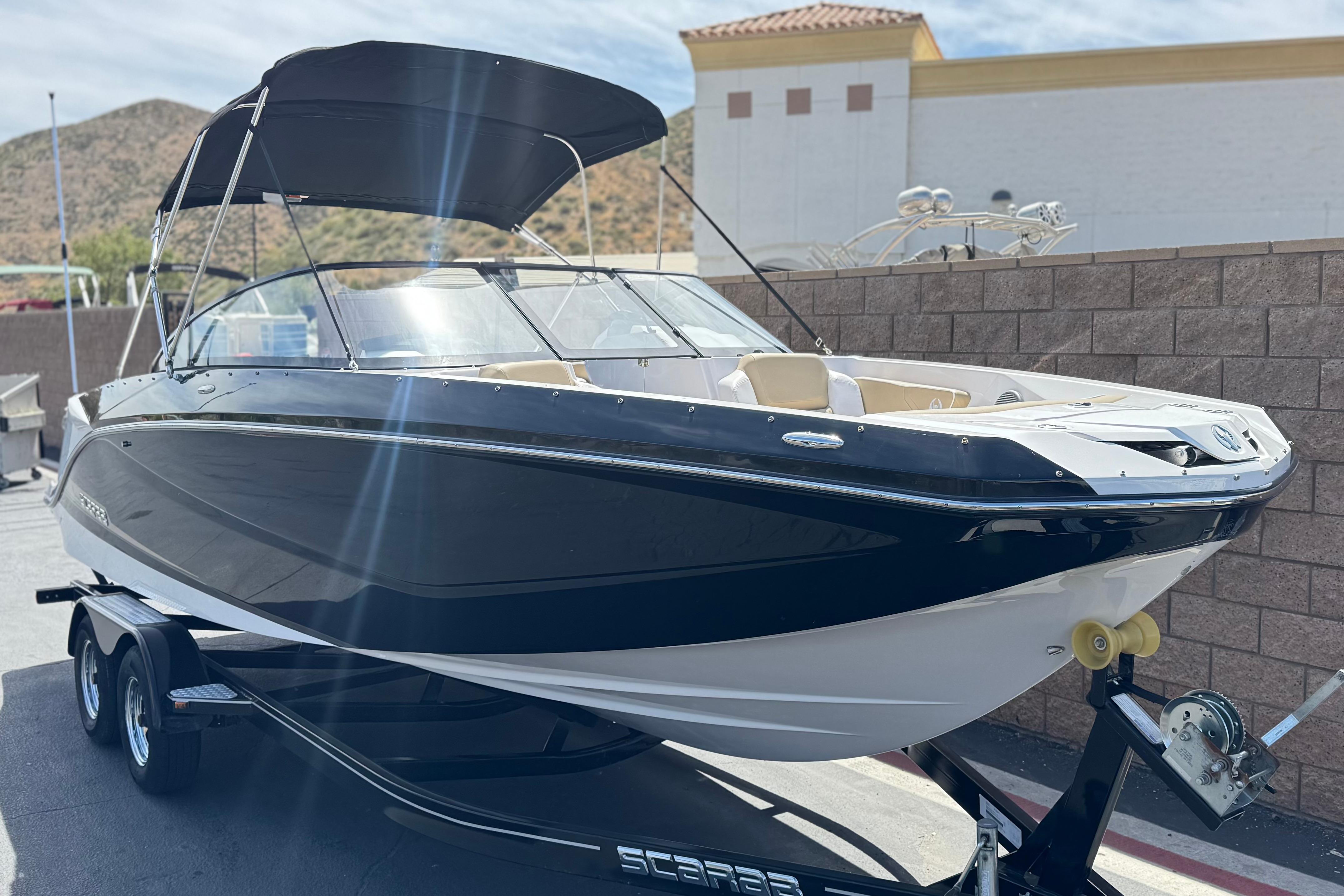 2017 Scarab 255 H.O. Platinum boat on trailer, black and white exterior, sunny day.