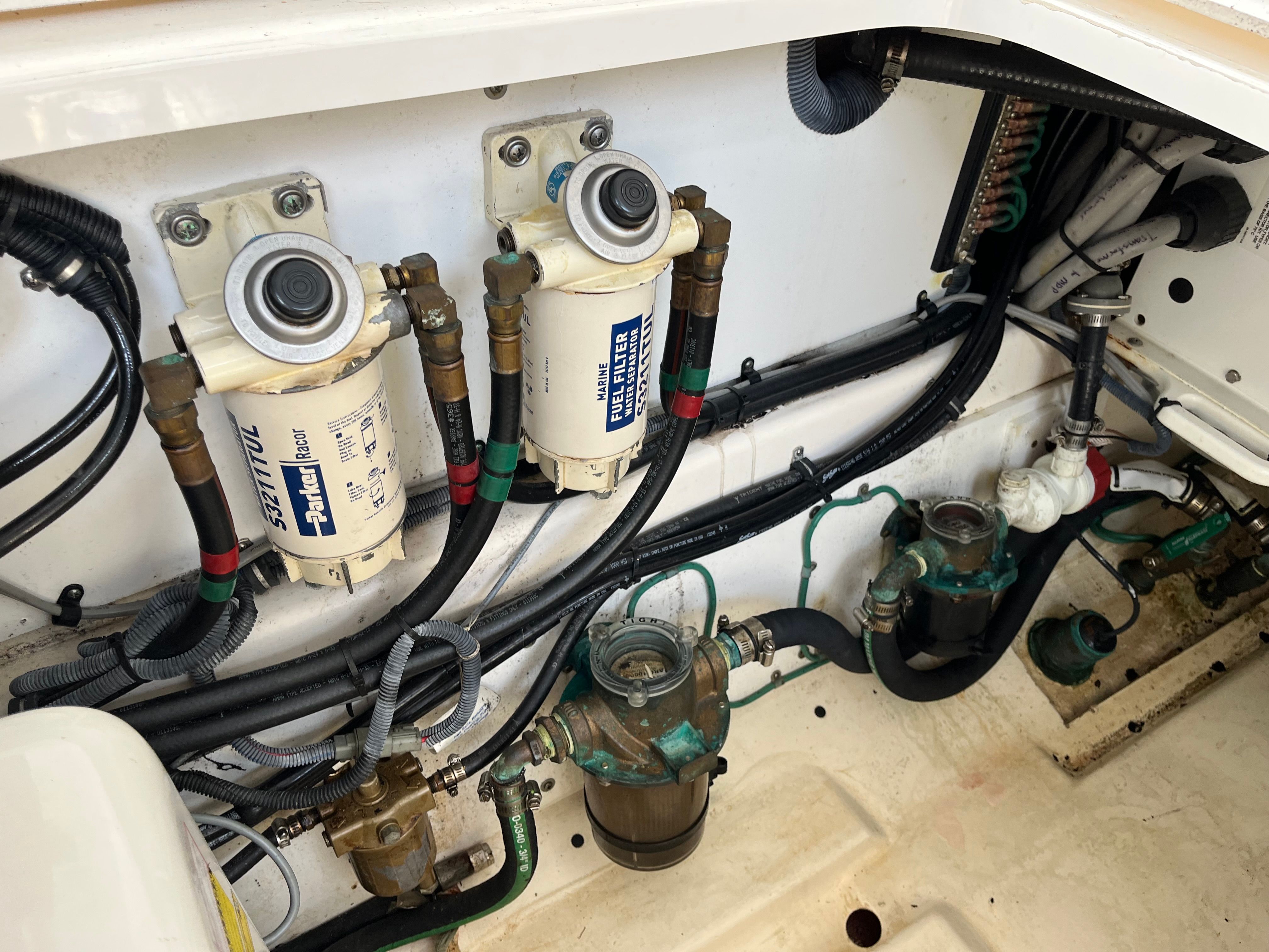 Engine compartment of 2010 Pursuit OS 345 Offshore with fuel filters and hoses.