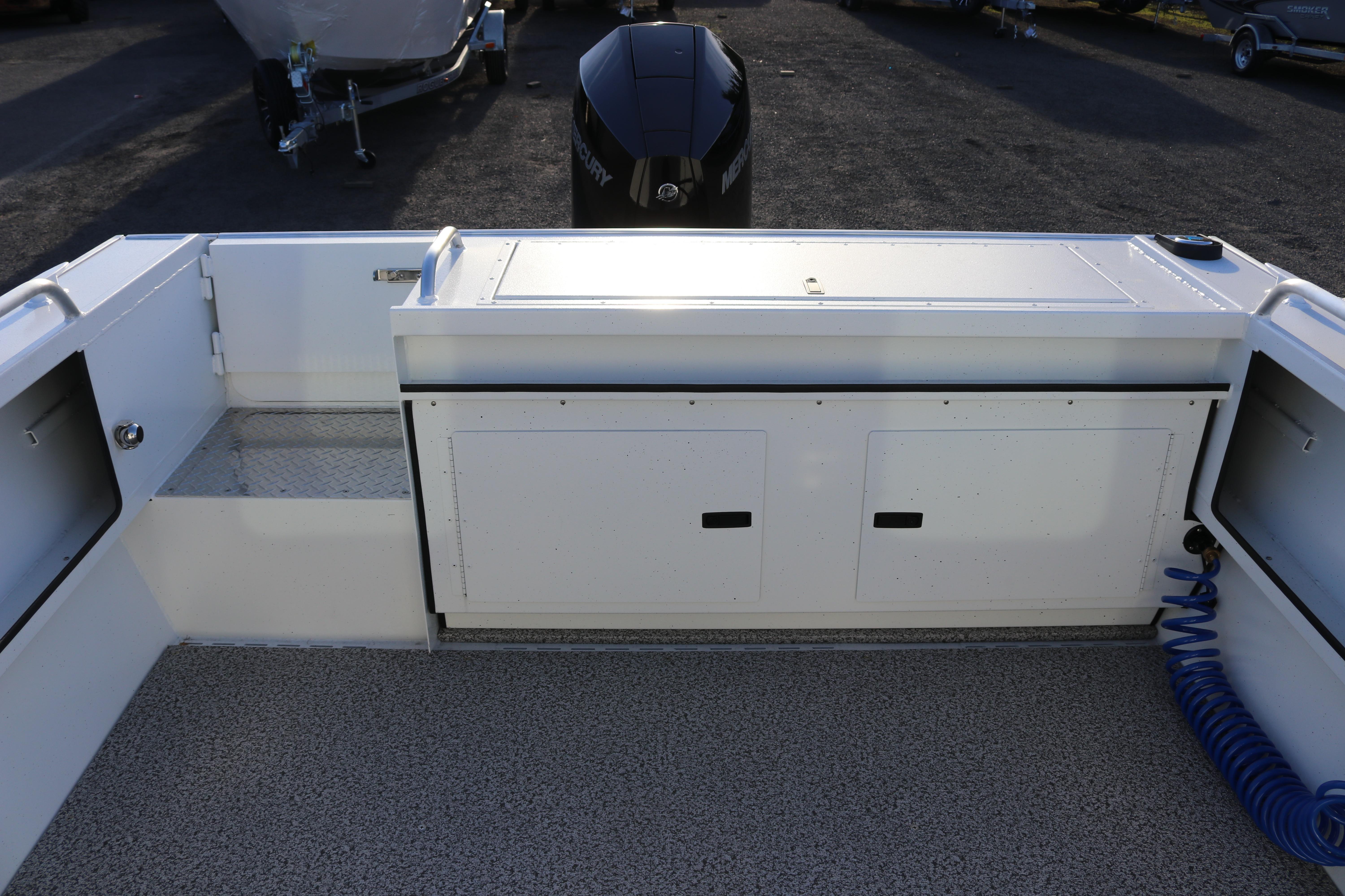 2026 Alumaweld Intruder Outboard 22 boat interior with storage compartments and outboard motor.