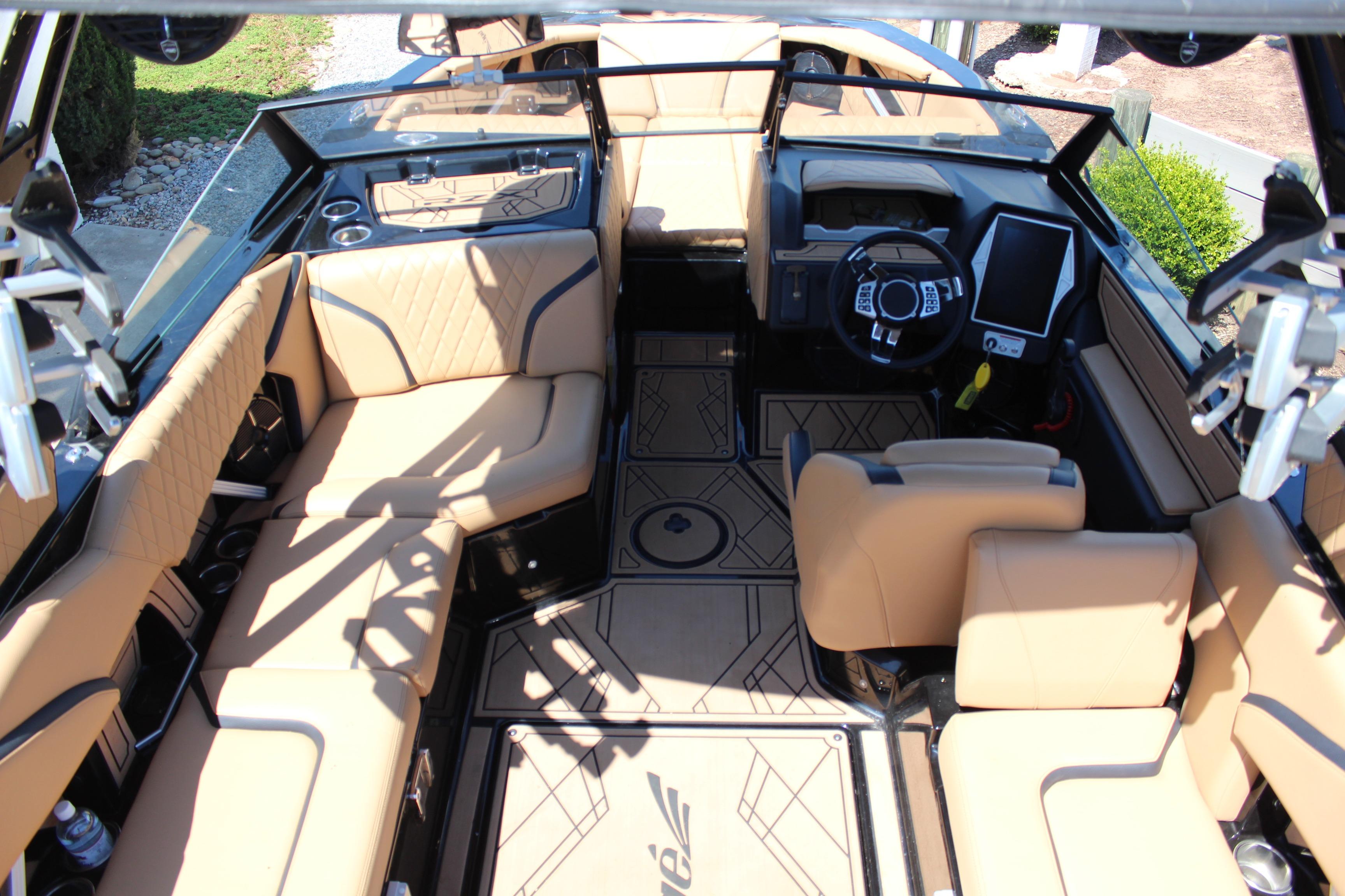 Interior of 2022 Tigé 22RZX boat with tan seating and modern dashboard.