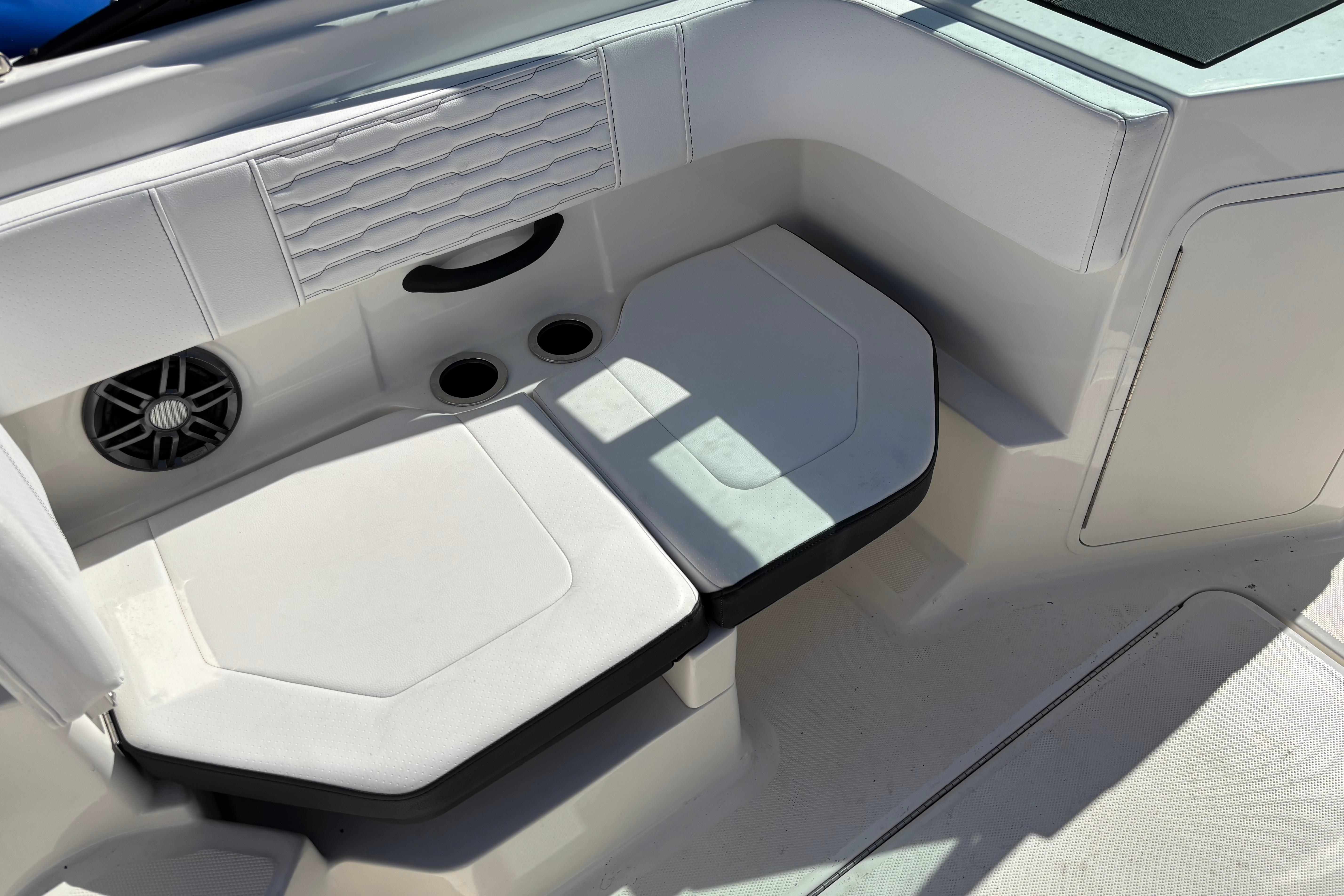 Interior seating of 2022 Sea Ray SPX 190 Outboard boat with cup holders and speaker.