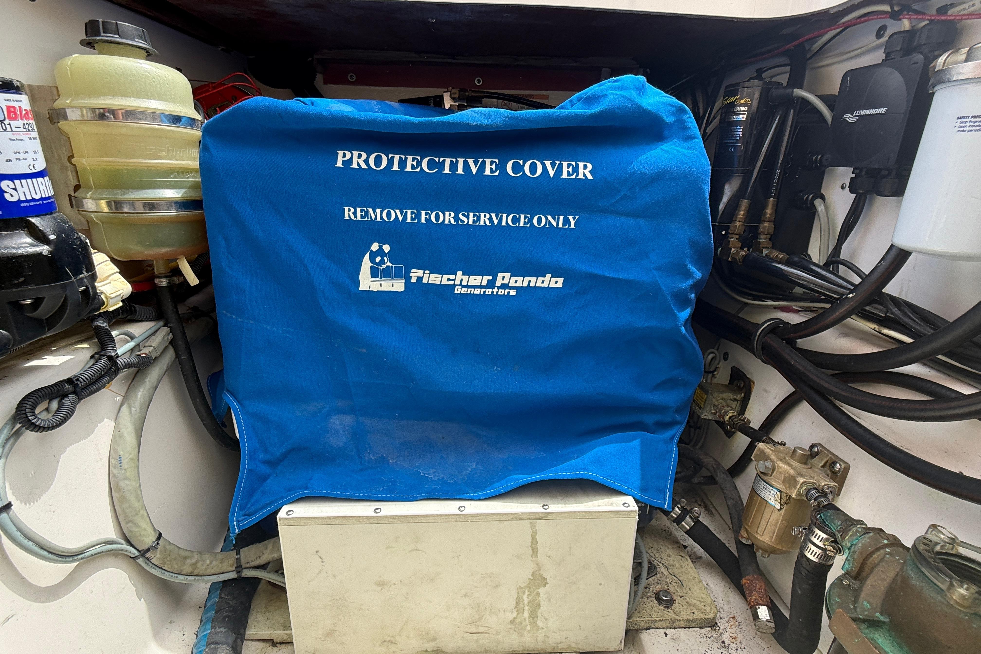 Engine compartment of 2012 Pursuit OS 345 Offshore with Fischer Panda generator cover.