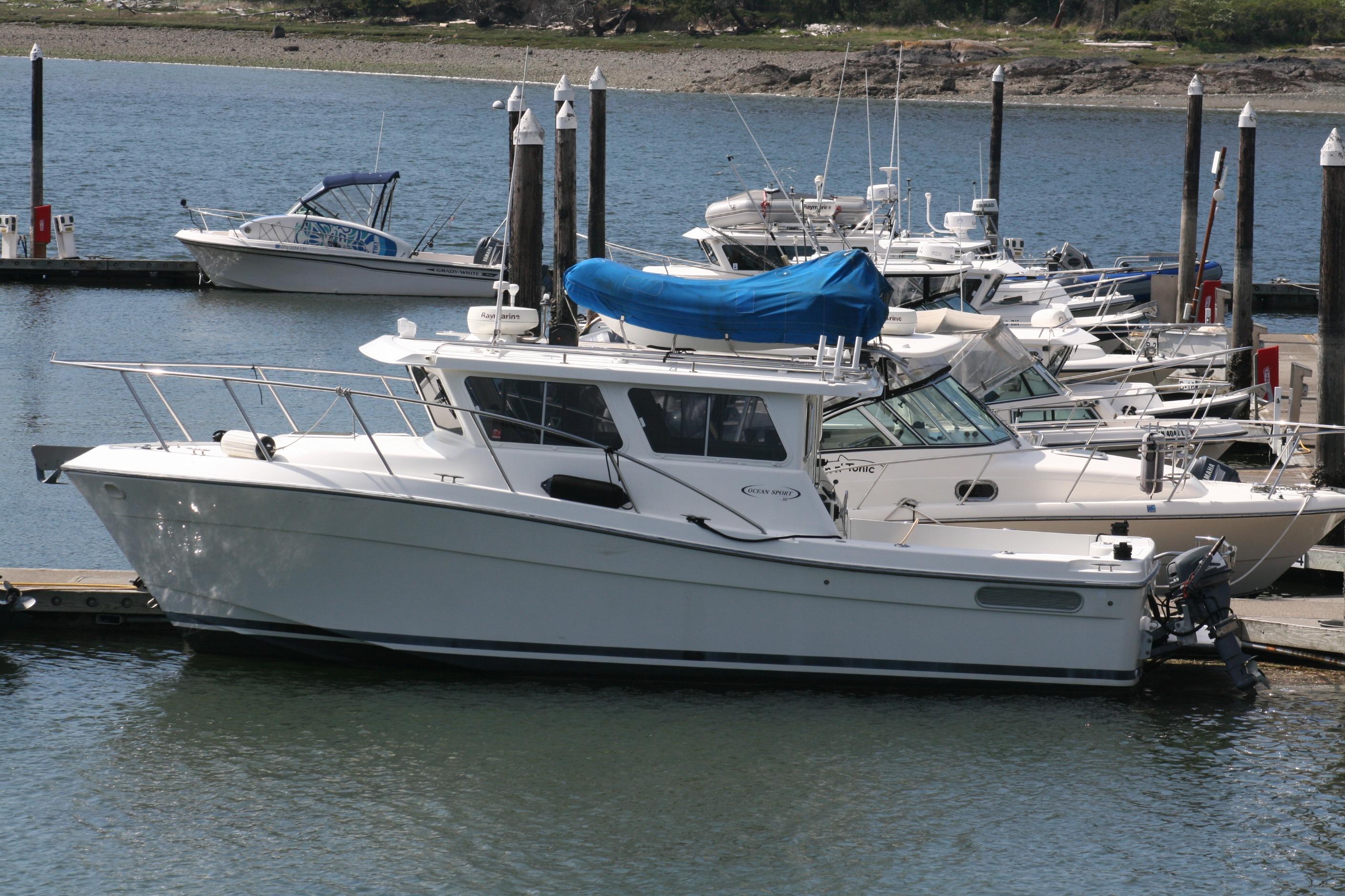 2005 Ocean Sport 30' boat docked at marina, surrounded by other vessels.