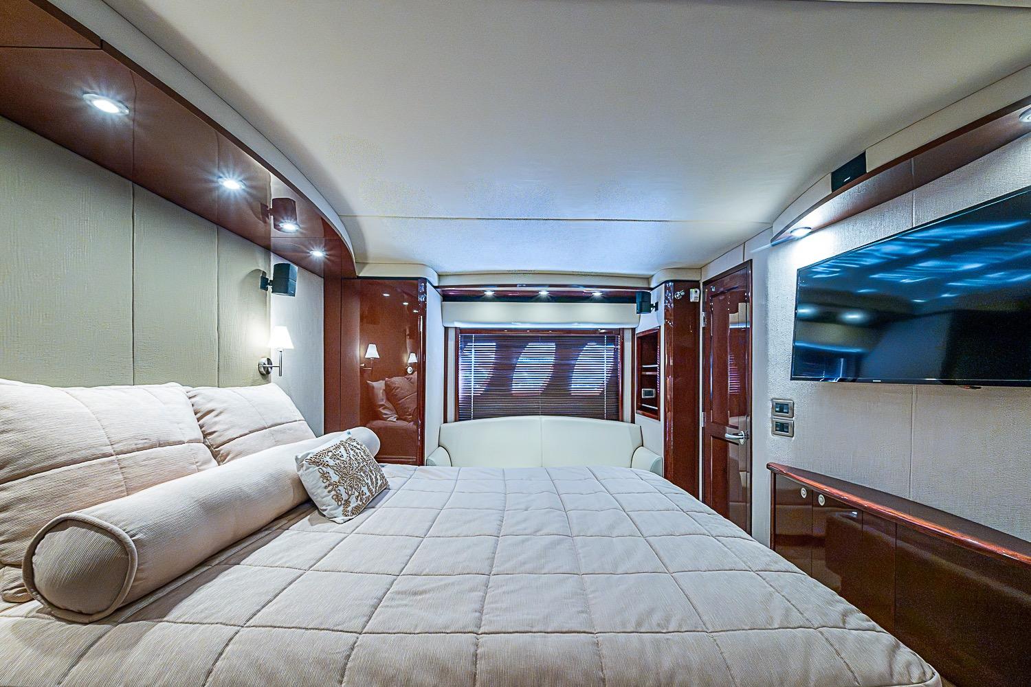 Luxurious bedroom interior of 2008 Sea Ray 60 Sundancer yacht with modern amenities.