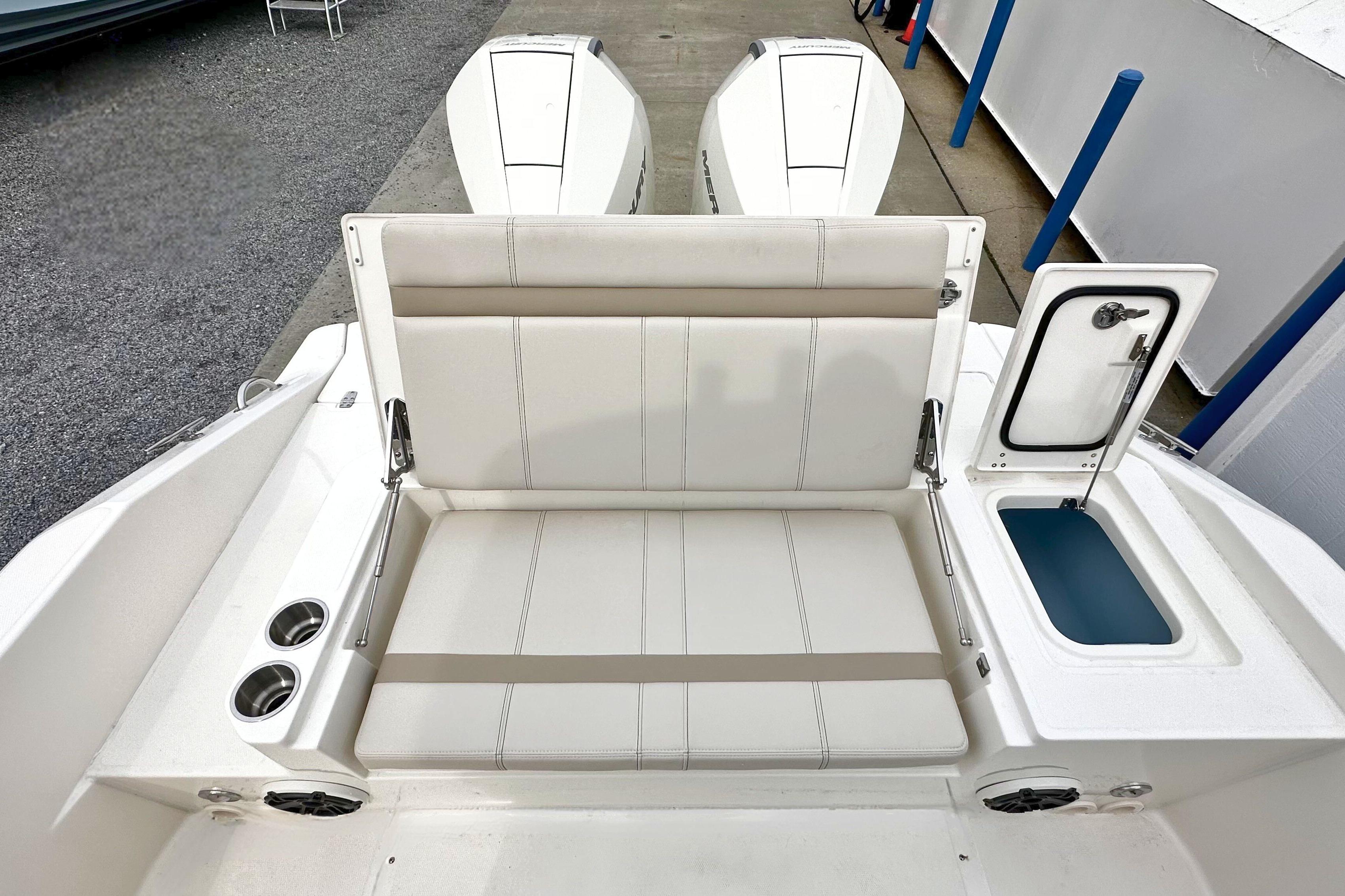 2026 Boston Whaler 280 Dauntless boat seating area with storage compartment.