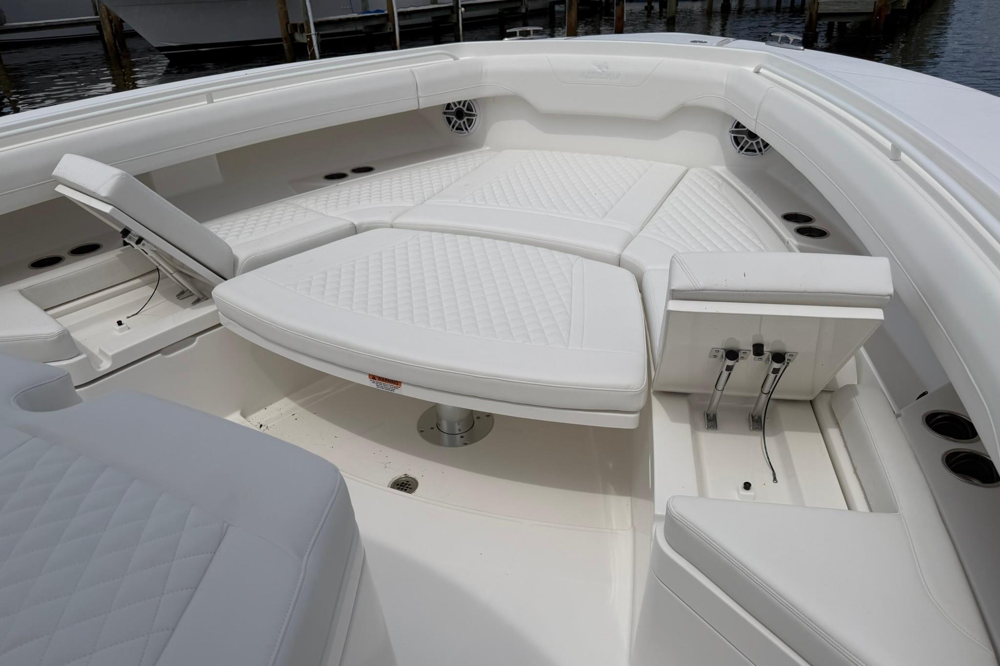 Luxurious seating area on a 2026 Regulator 37 boat, featuring white cushioned seats.