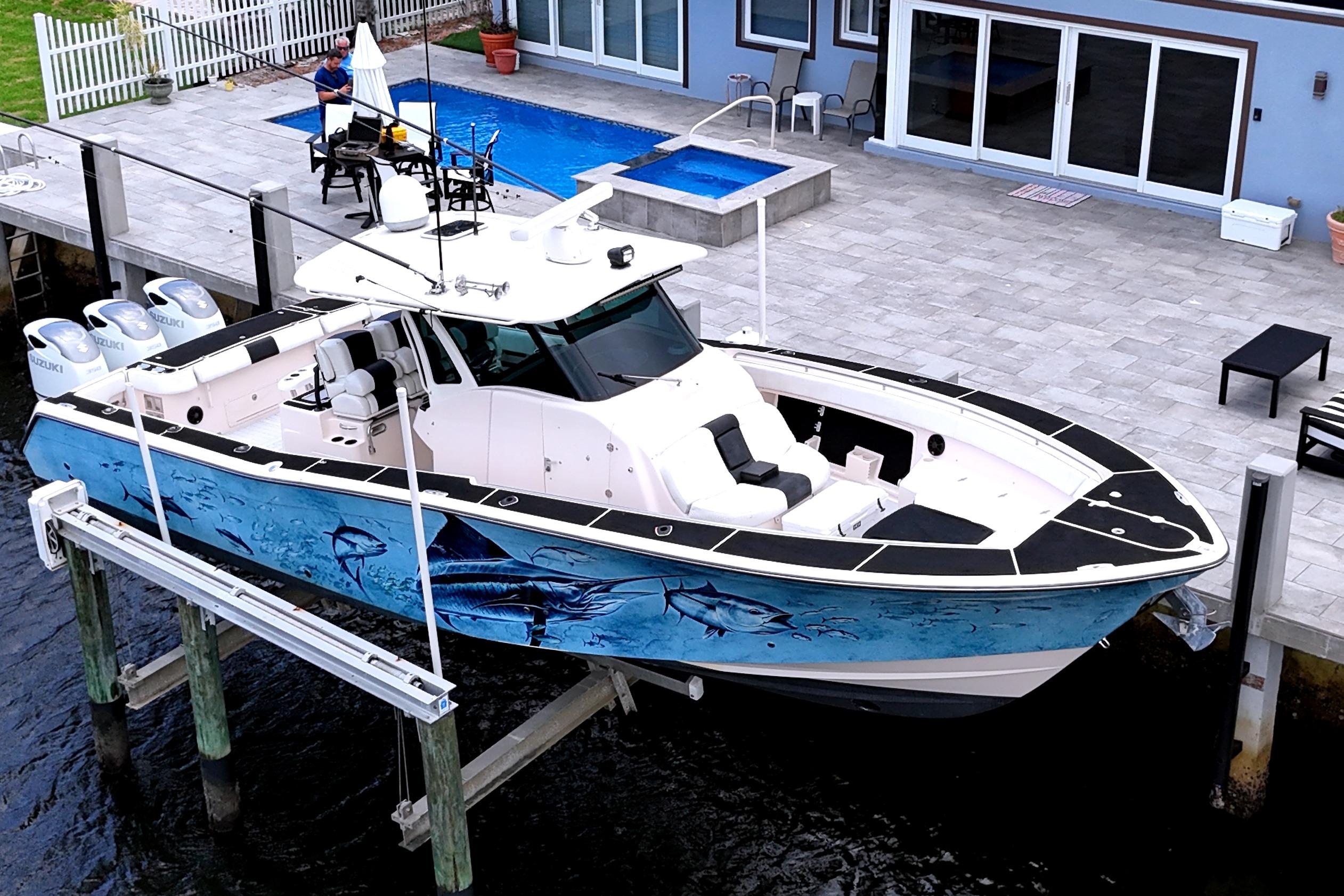 2010 Grady-White Canyon 366 boat docked, featuring vibrant marine-themed hull artwork.