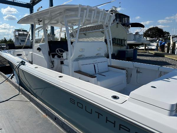 2025 Southport 33 DC boat docked, featuring sleek design and spacious seating.