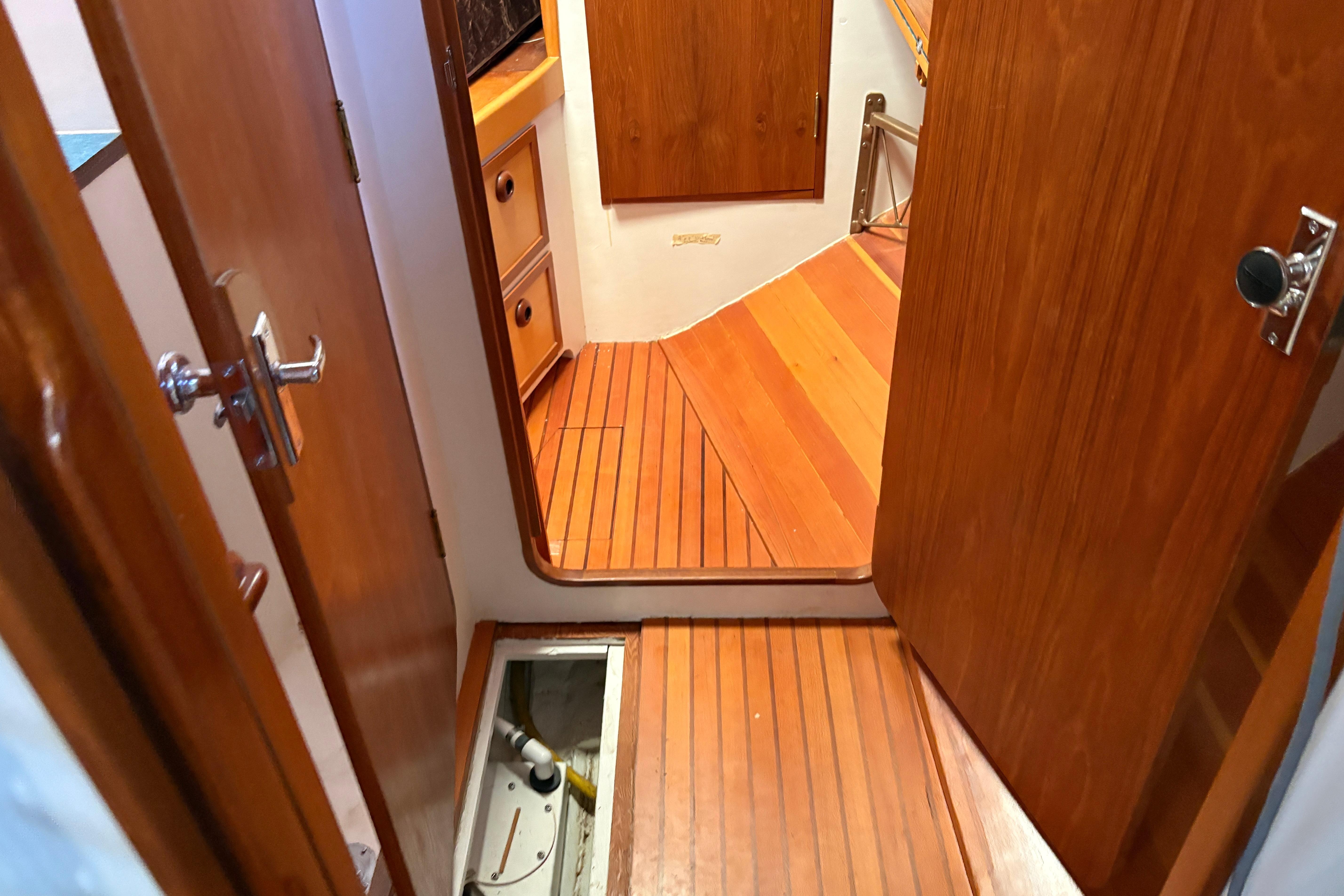 Interior of 2017 Bruce Roberts Spray boat with wooden flooring and cabinetry.