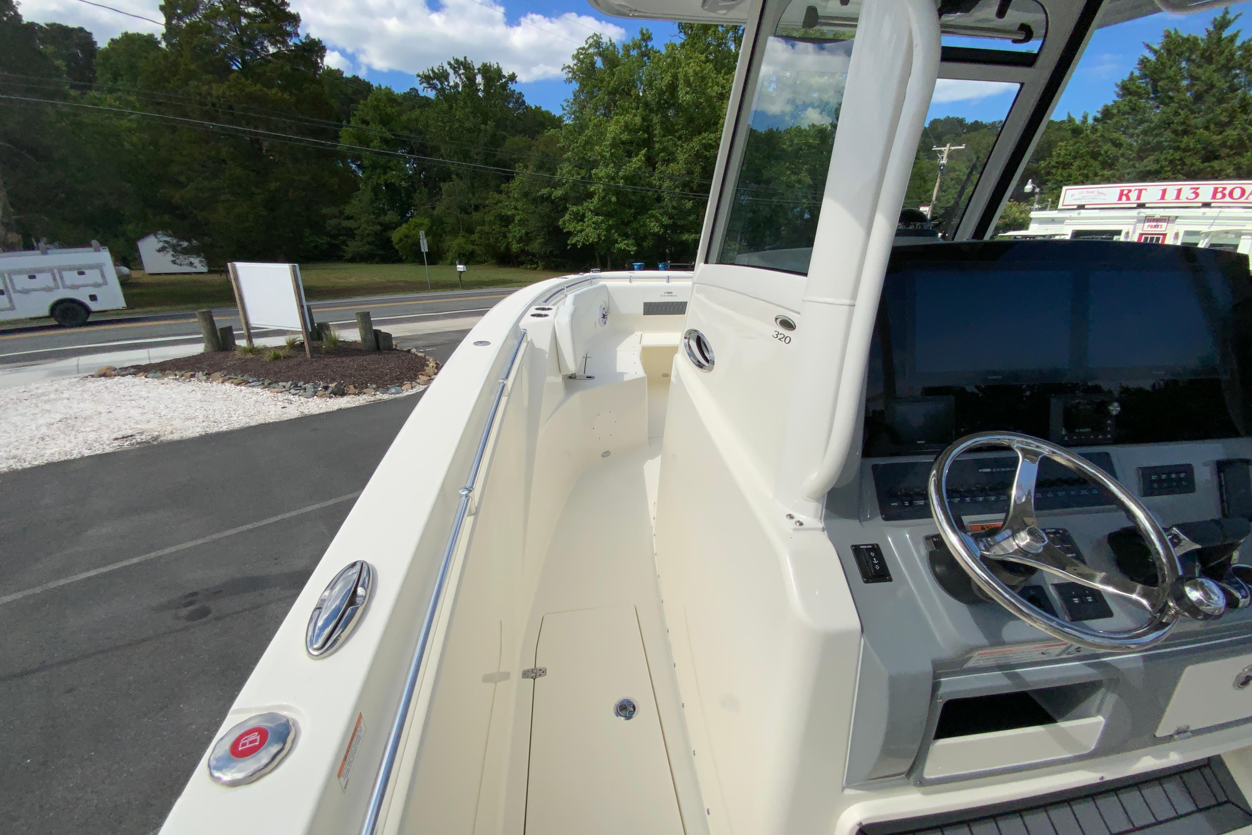2027 Cobia 320 Center Console boat with sleek helm and modern controls.