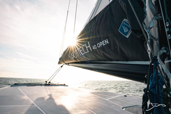 2025 Nautitech 40 Open catamaran sailing at sunset, showcasing sleek design and performance.