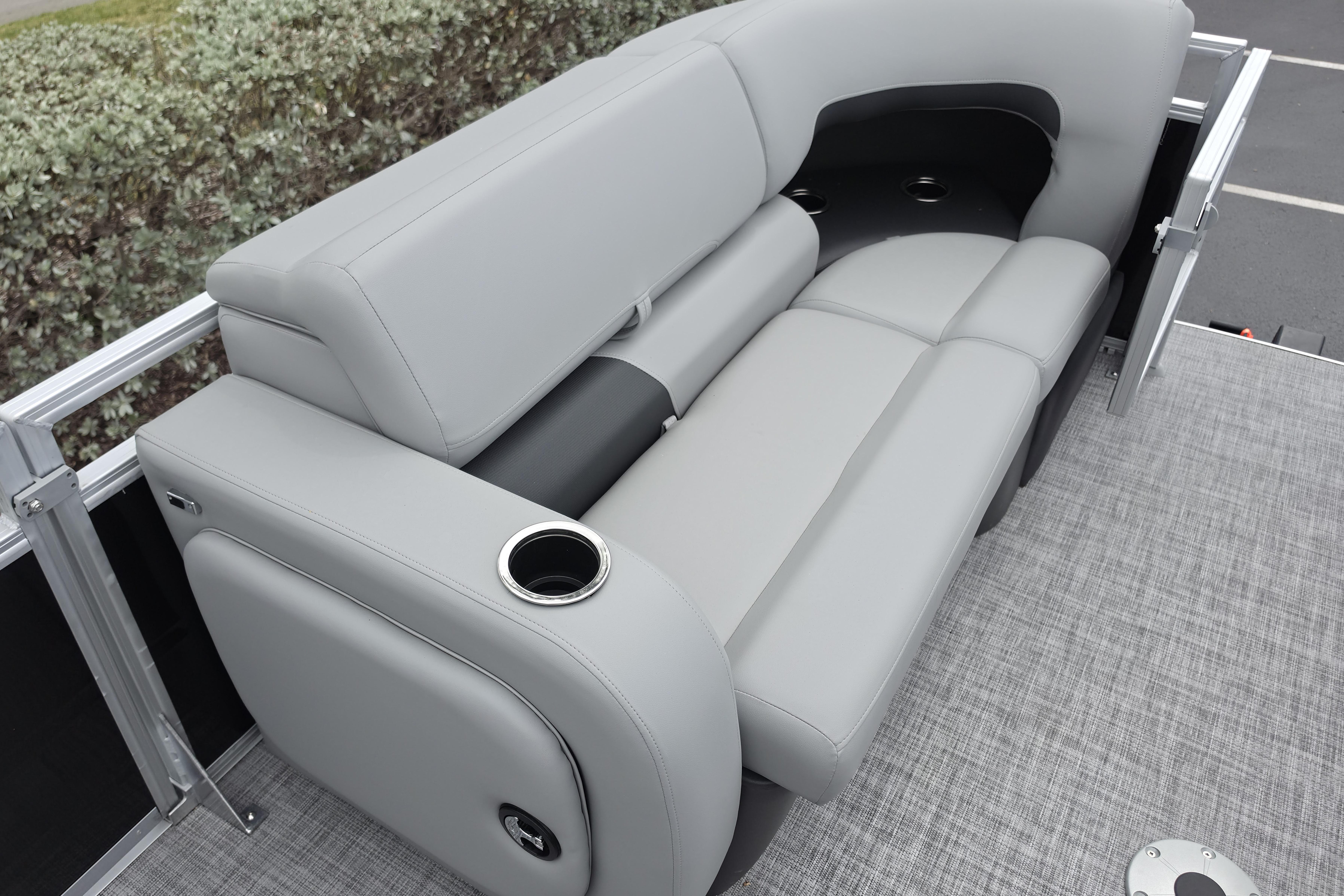 Luxurious seating on 2026 Sun Tracker SportFish 22 XP3 pontoon boat, featuring cup holders.