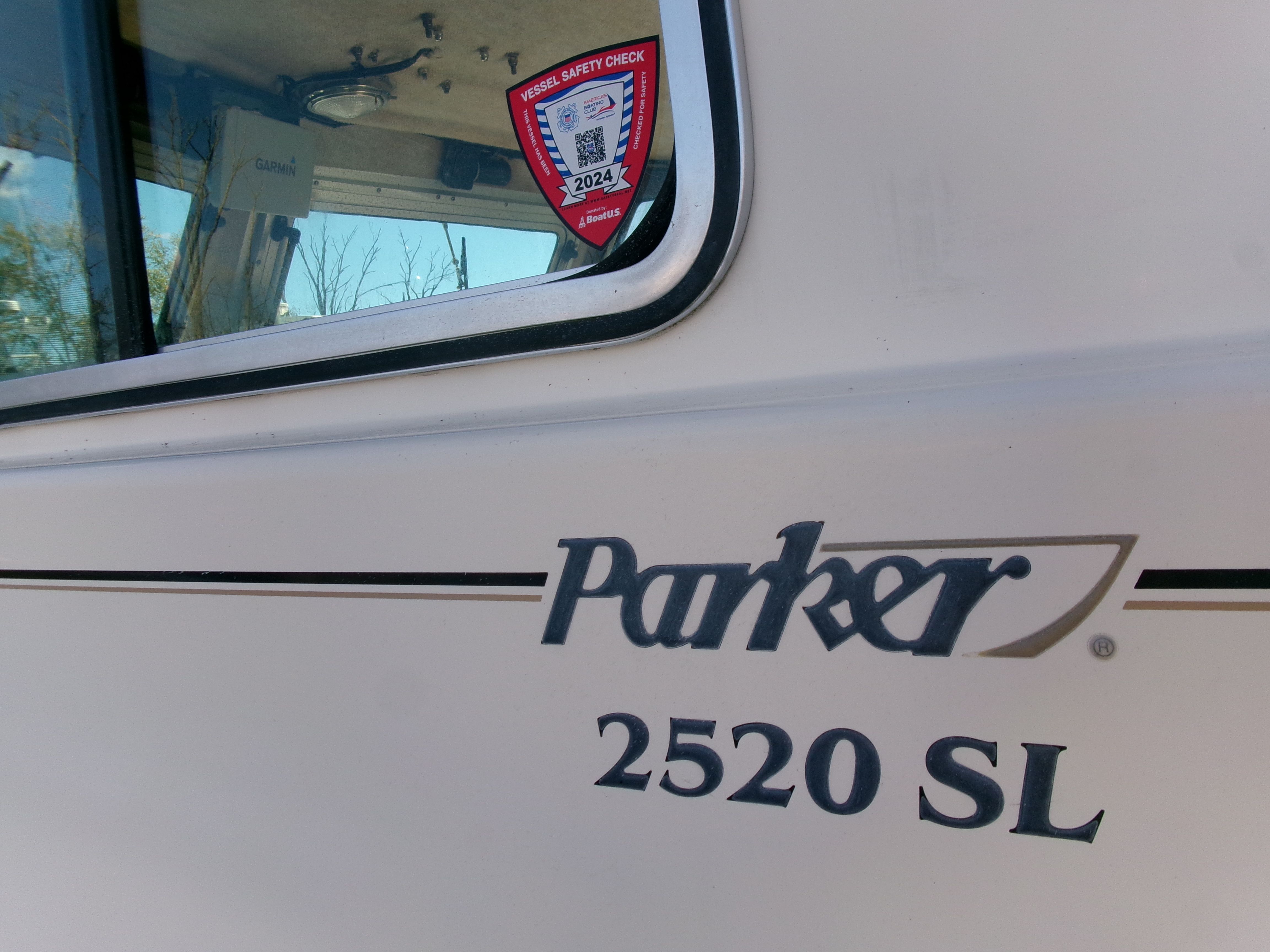 Close-up of Parker 2520 XL Sport Cabin with safety sticker.