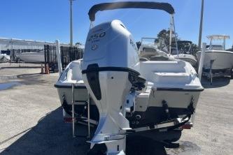 2022 Key West 239 DFS boat with powerful outboard motor, parked in a marina.