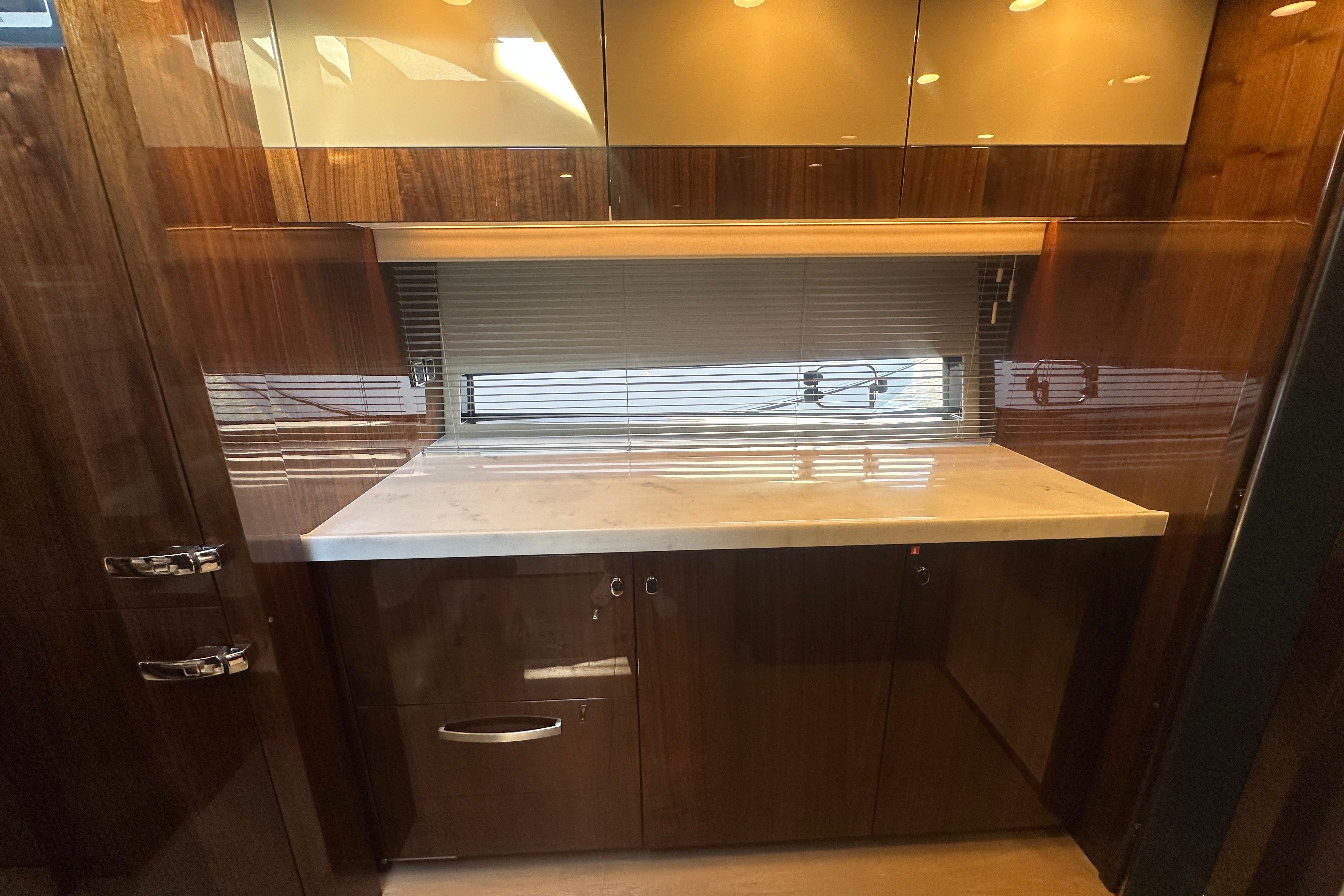Luxurious interior of 2024 Fairline Squadron 50 yacht with sleek wood cabinetry.