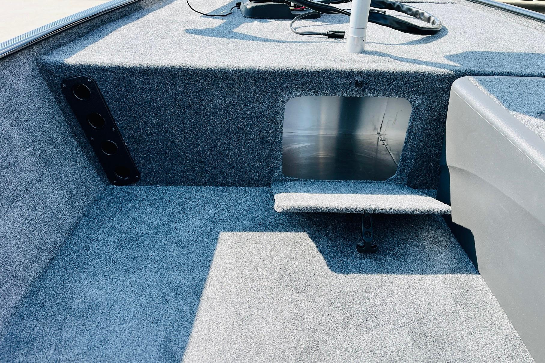 2026 Tracker Bass Tracker Classic XL boat interior with carpeted storage compartment.
