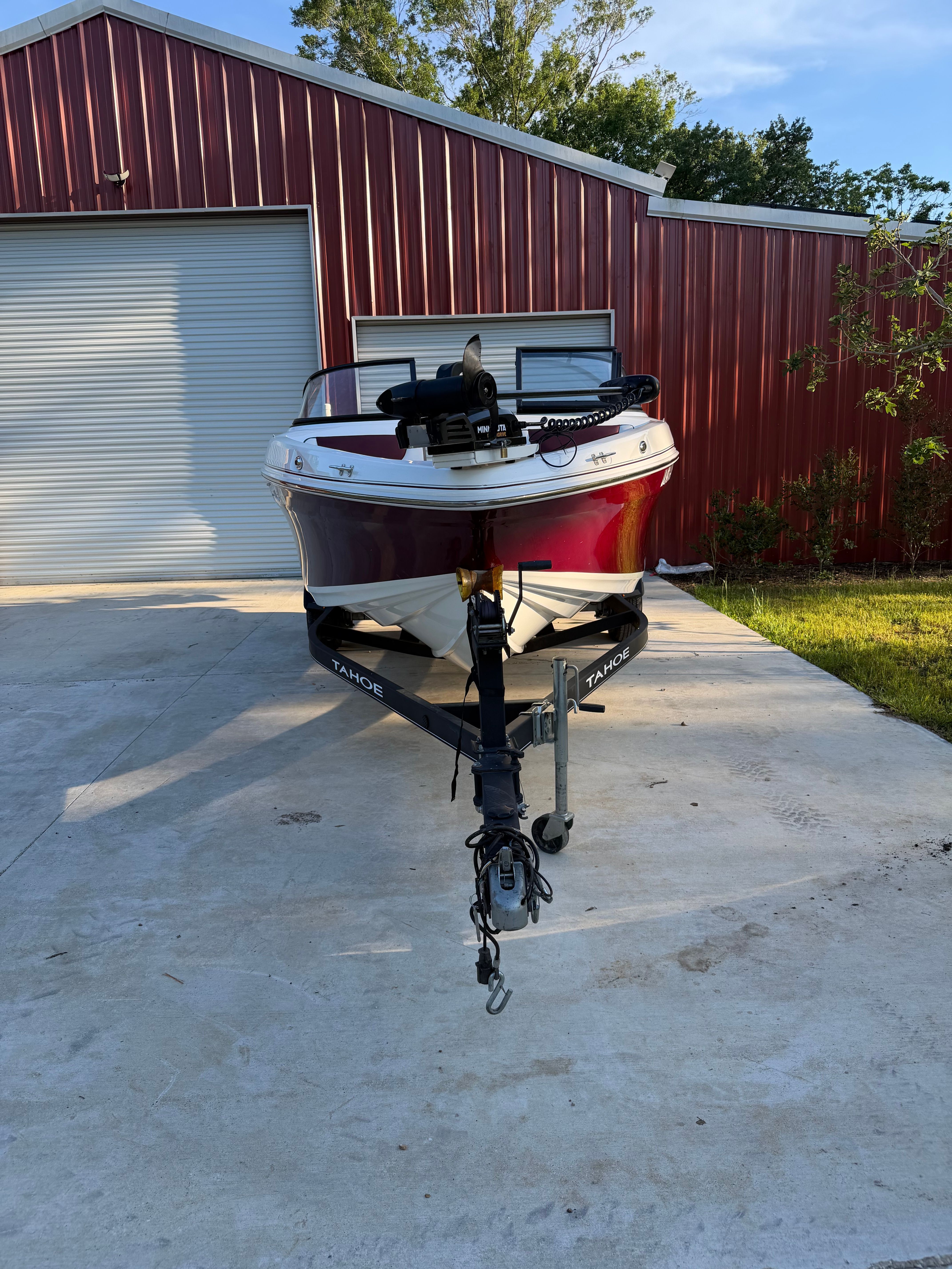 2020 Tracker Tahoe 550TF boat in front of red building.