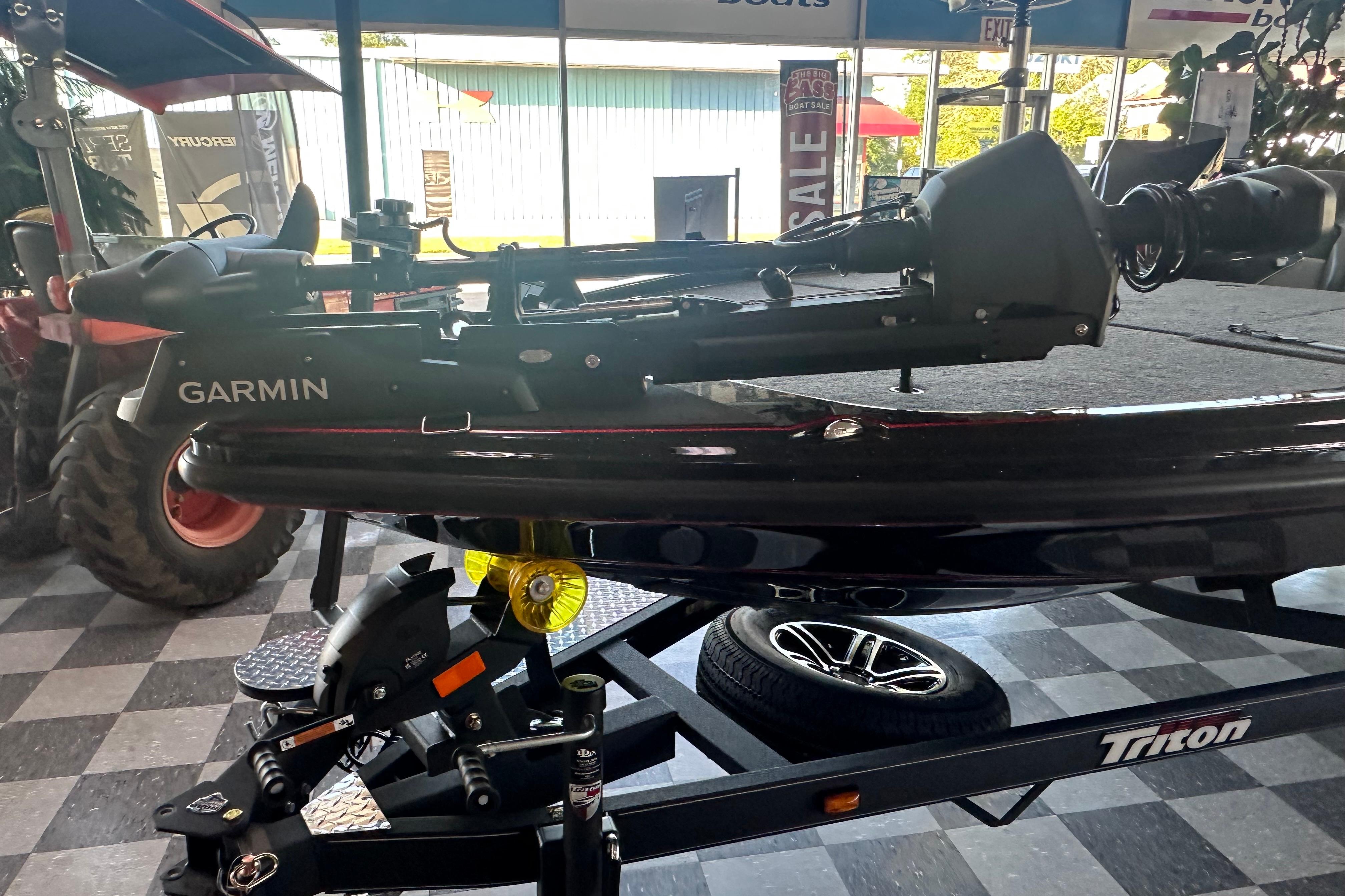 2026 Triton 20XP Patriot boat with Garmin equipment on display in showroom.