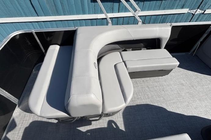 2026 Sun Tracker Party Barge 18 DLX with gray seating and spacious deck layout.
