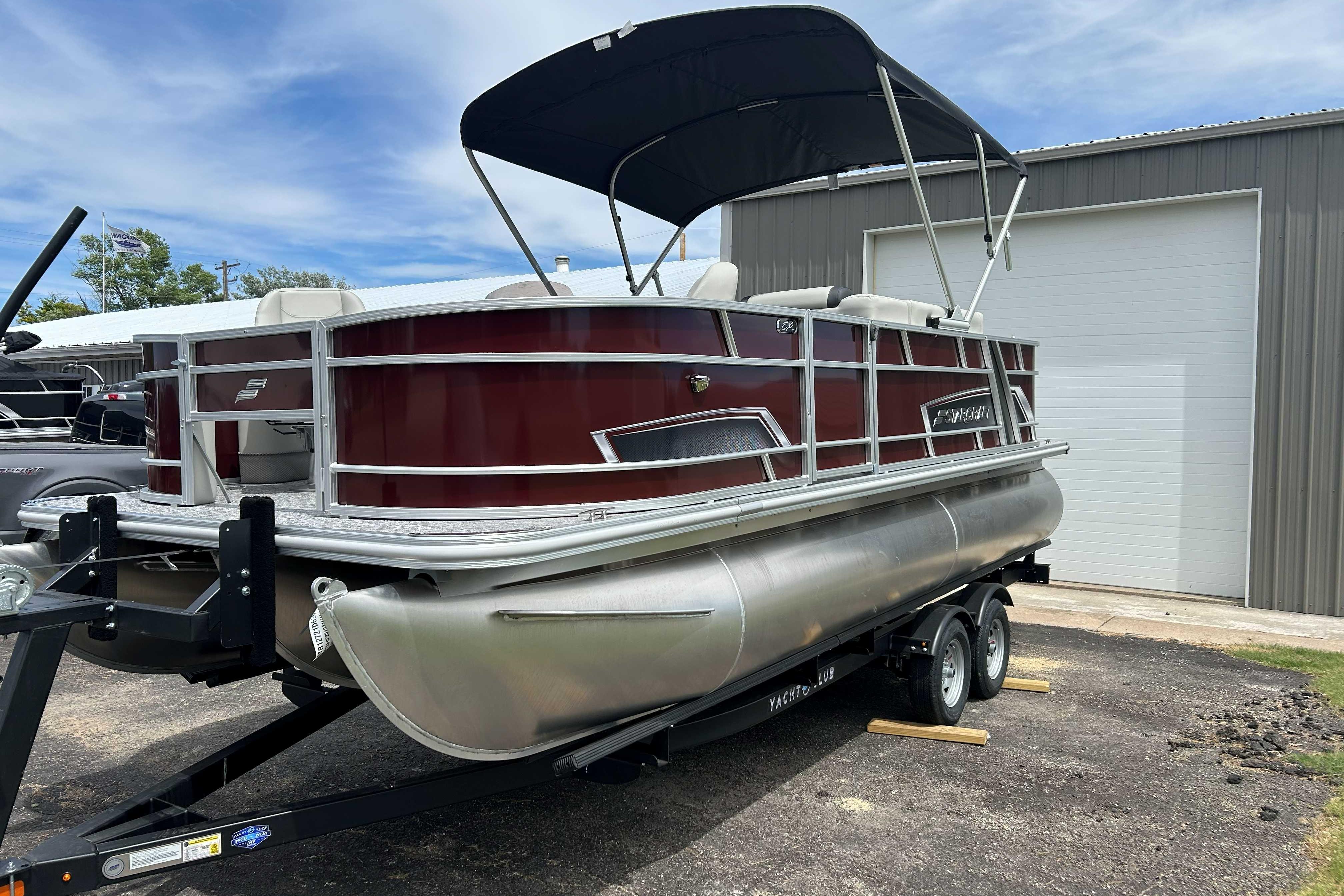 2026 Starcraft EX 20 F pontoon boat on trailer, parked outdoors.
