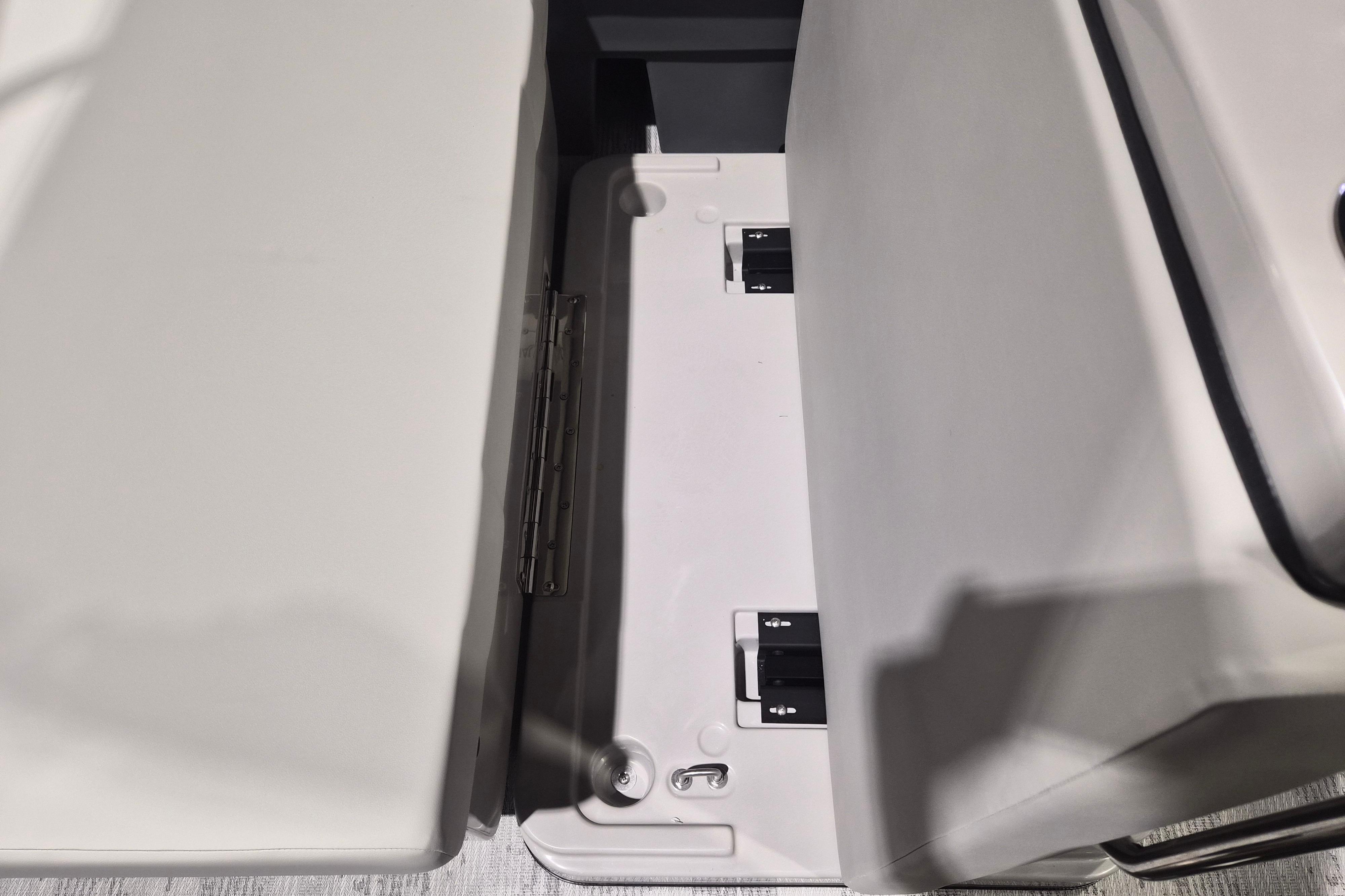 Interior seating detail of 2026 Sylvan R-22 LZ DH boat, showcasing storage compartment.