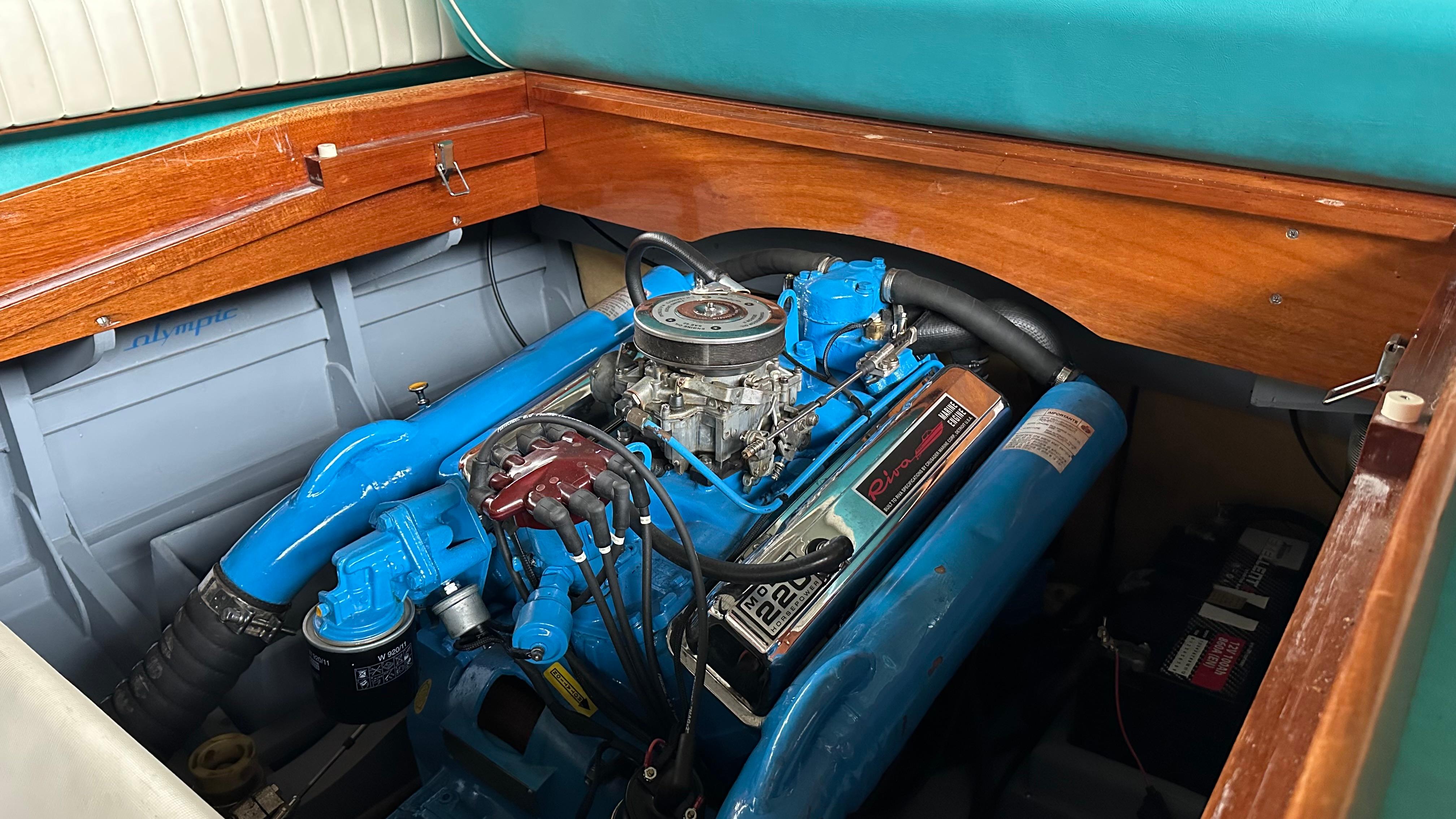 1970 Riva Olympic boat engine with blue components and wooden paneling.