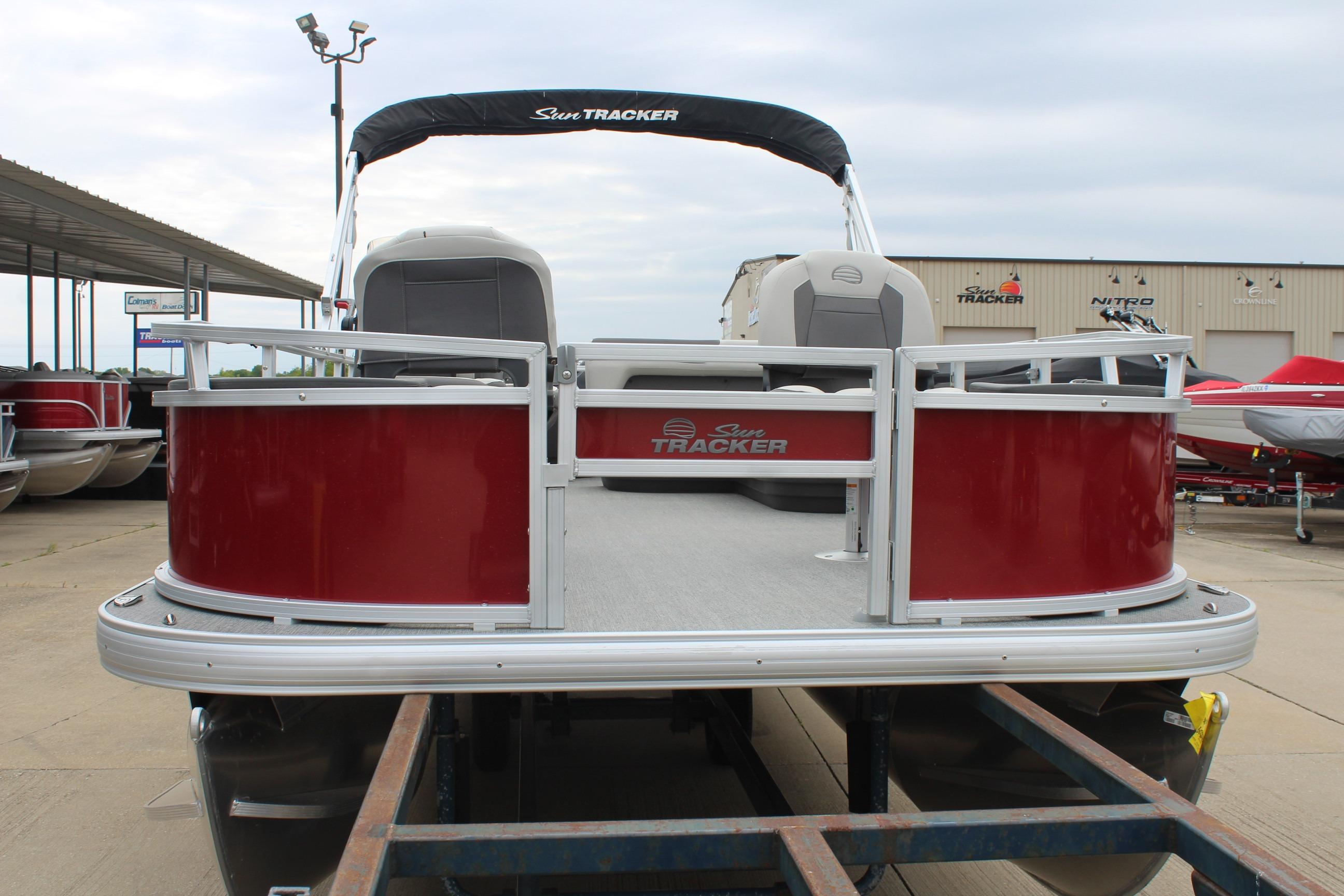 2026 Sun Tracker Bass Buggy 18 DLX pontoon boat, red exterior, displayed outdoors.