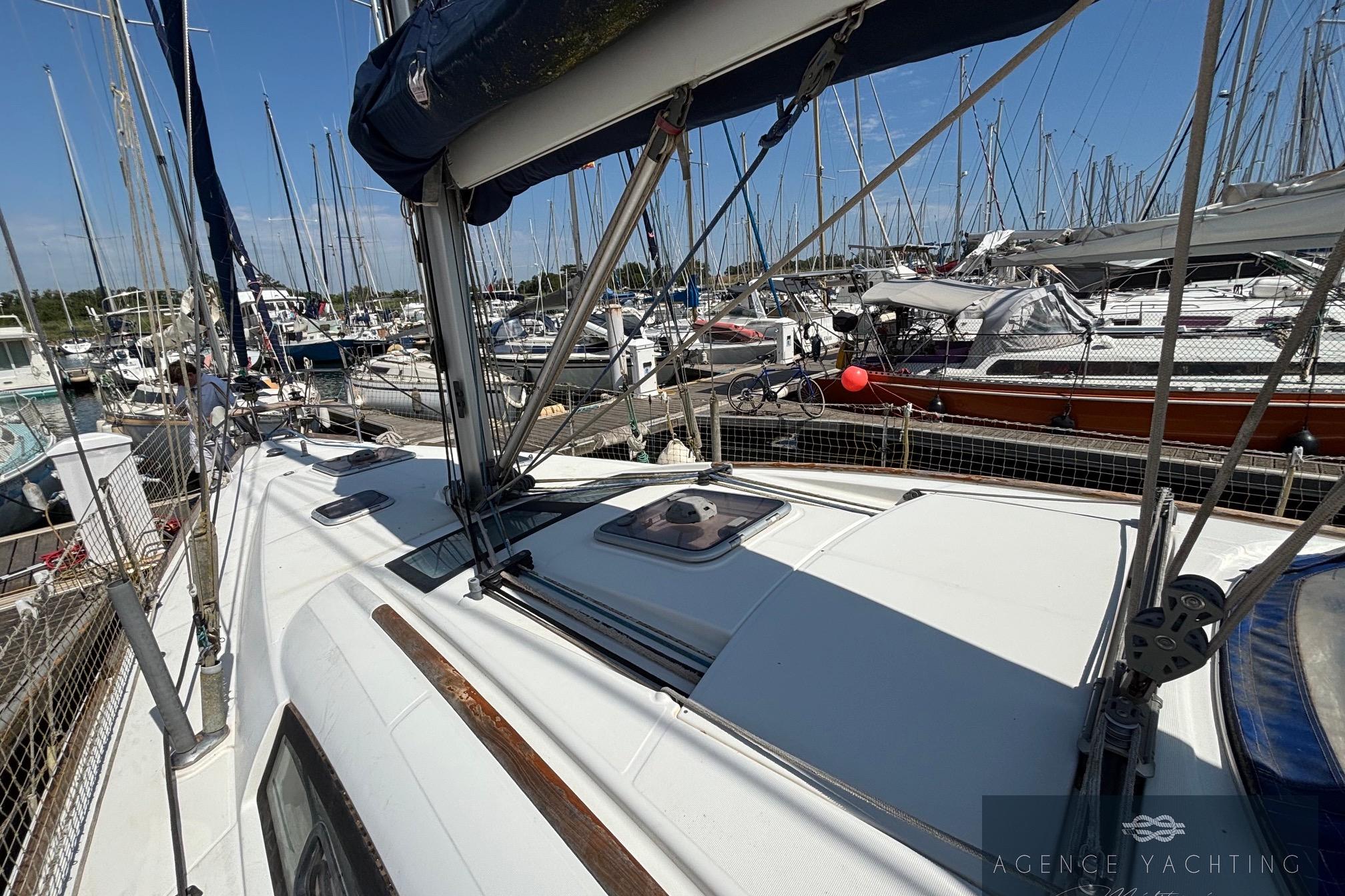 2008 Beneteau Oceanis 40 sailboat docked in a marina, surrounded by other boats.