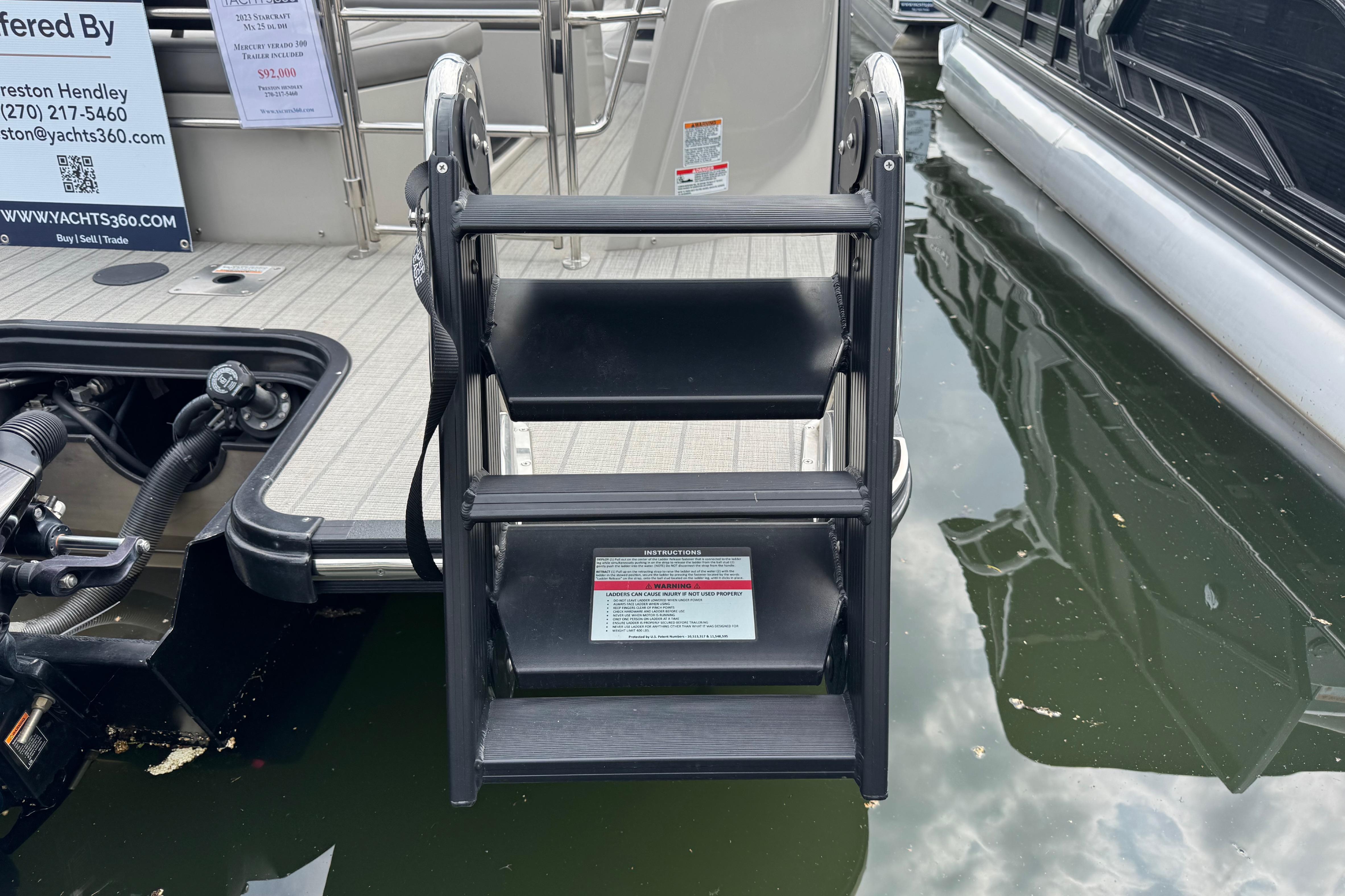 2023 Starcraft MX 25 DL DH boat ladder at dockside, showcasing sleek design and functionality.