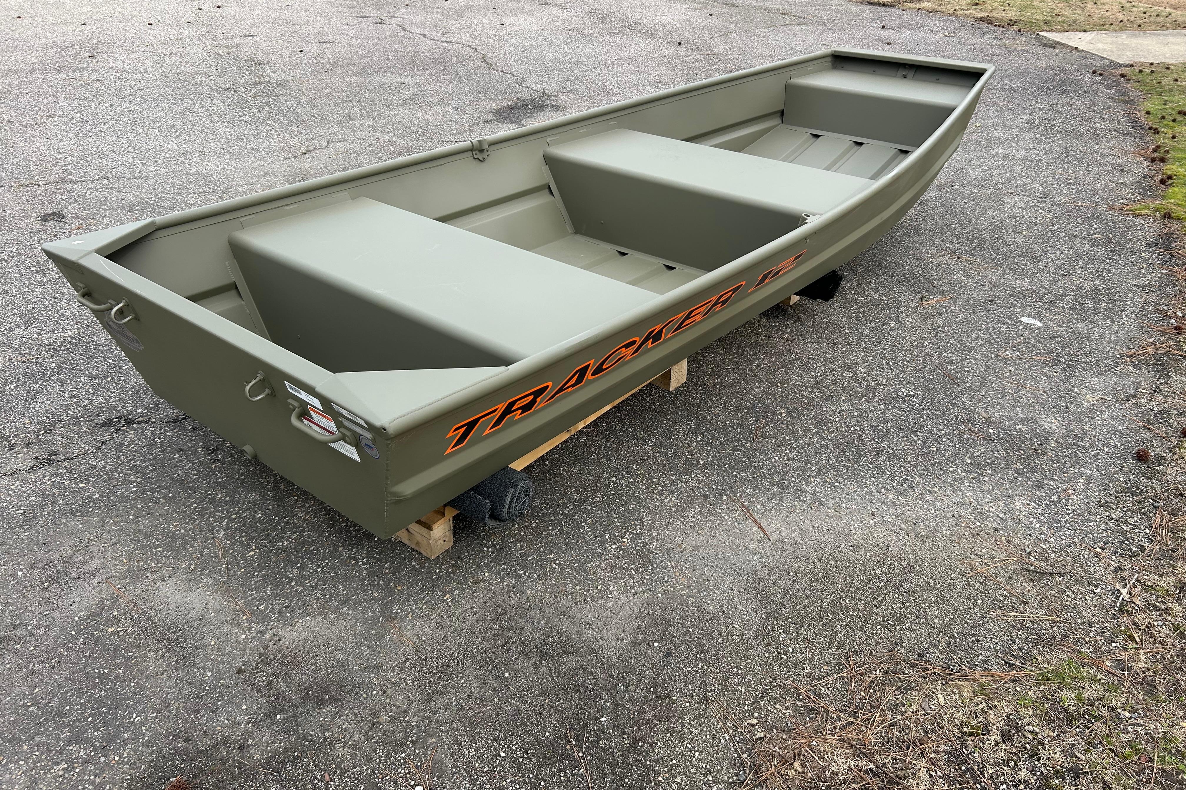 2026 Tracker Grizzly 12 Jon boat on pavement, showcasing its sturdy design.