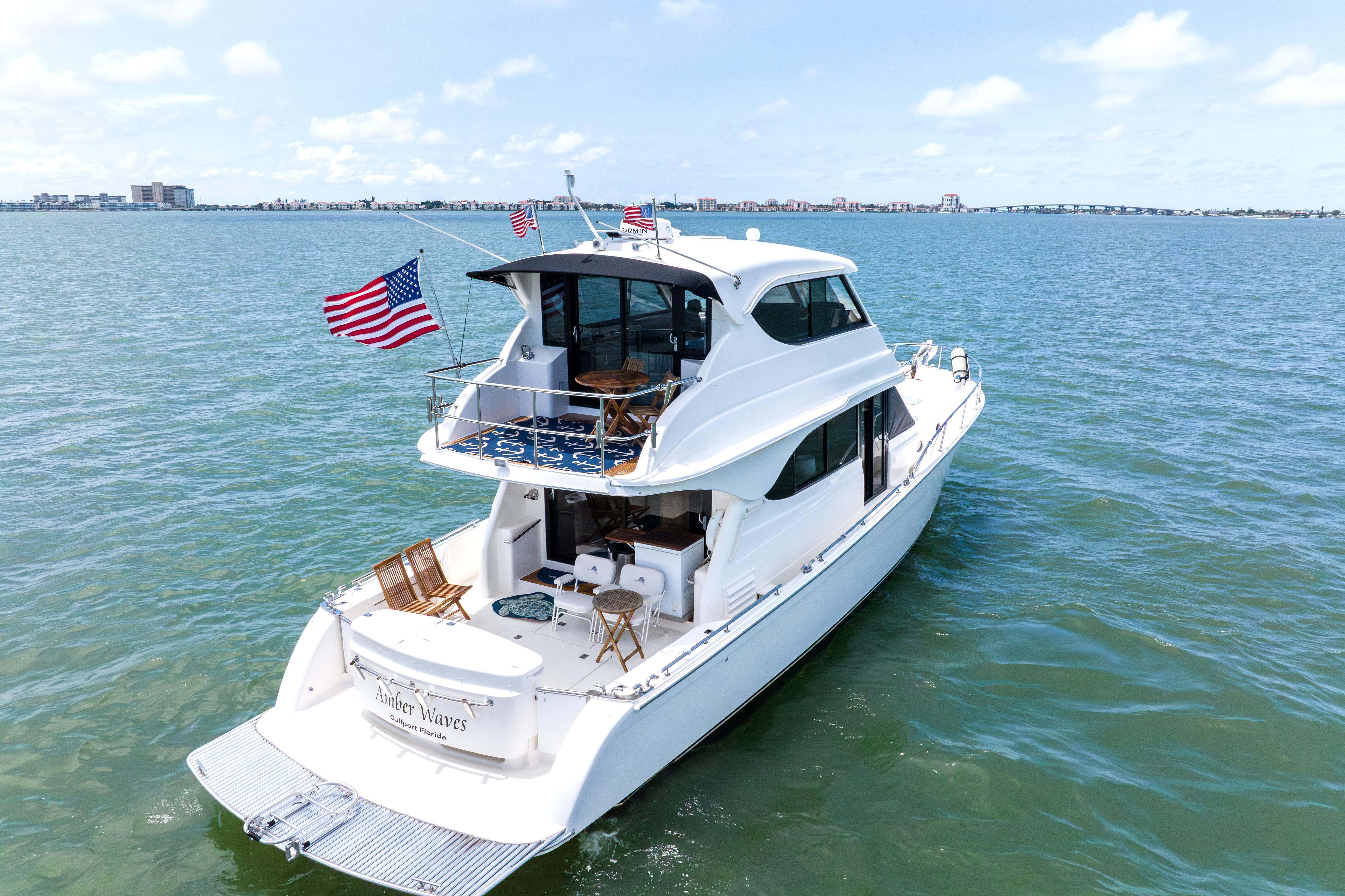 2008 Maritimo 52 yacht cruising on open water with American flags displayed.