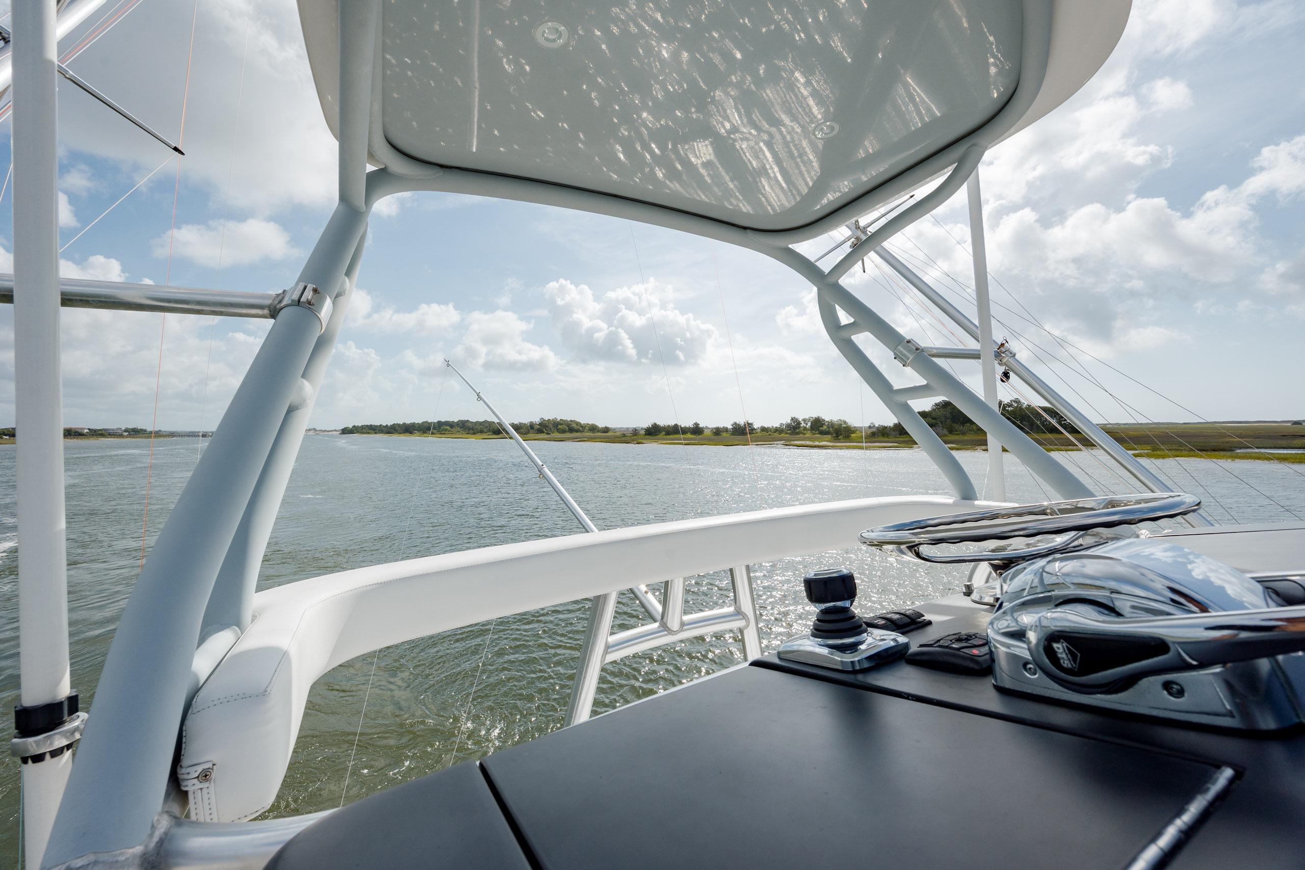 2015 Jarrett Bay Hardtop Express Sportfish helm with scenic waterway view.