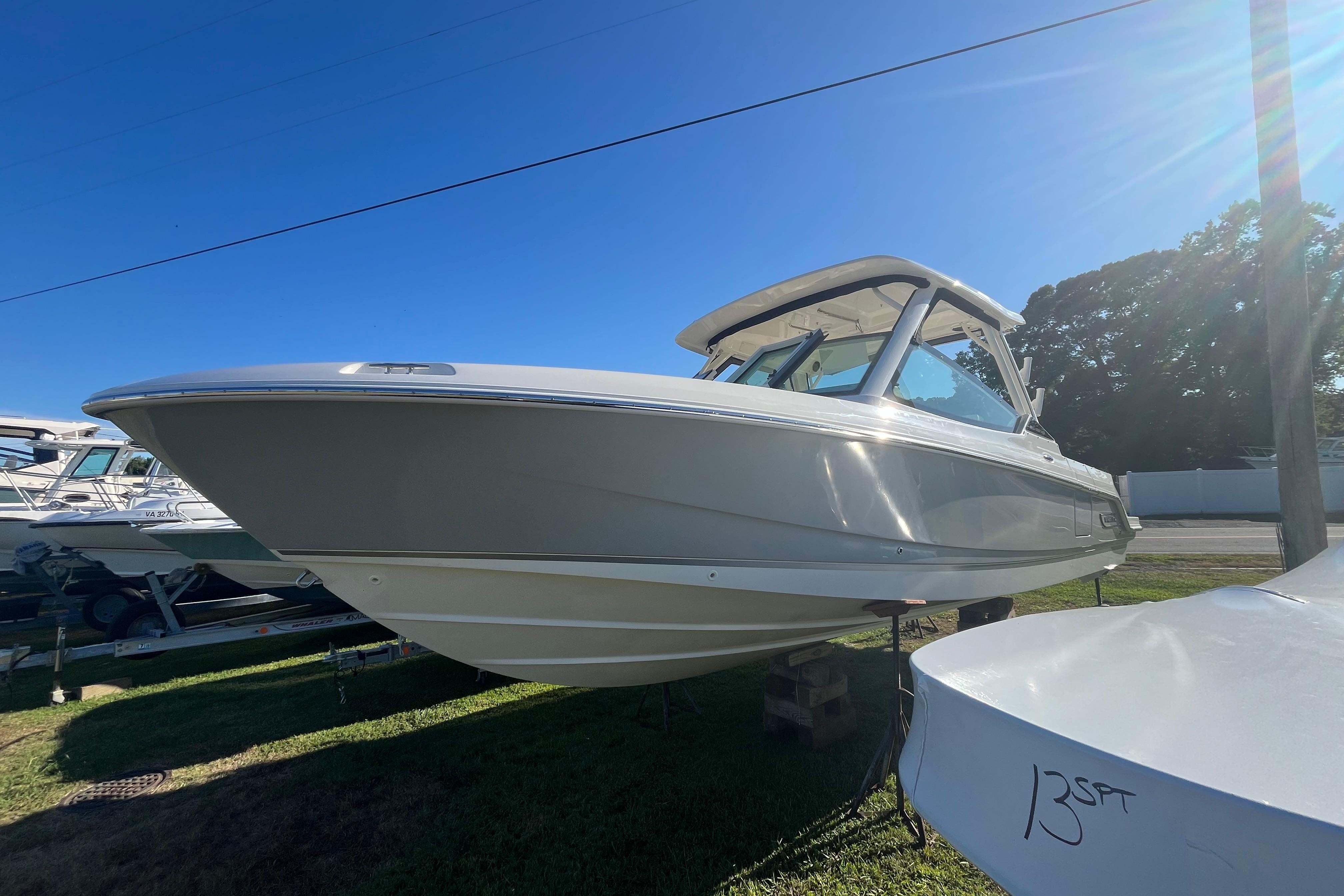 2026 Boston Whaler 280 Vantage boat displayed outdoors under clear blue sky.