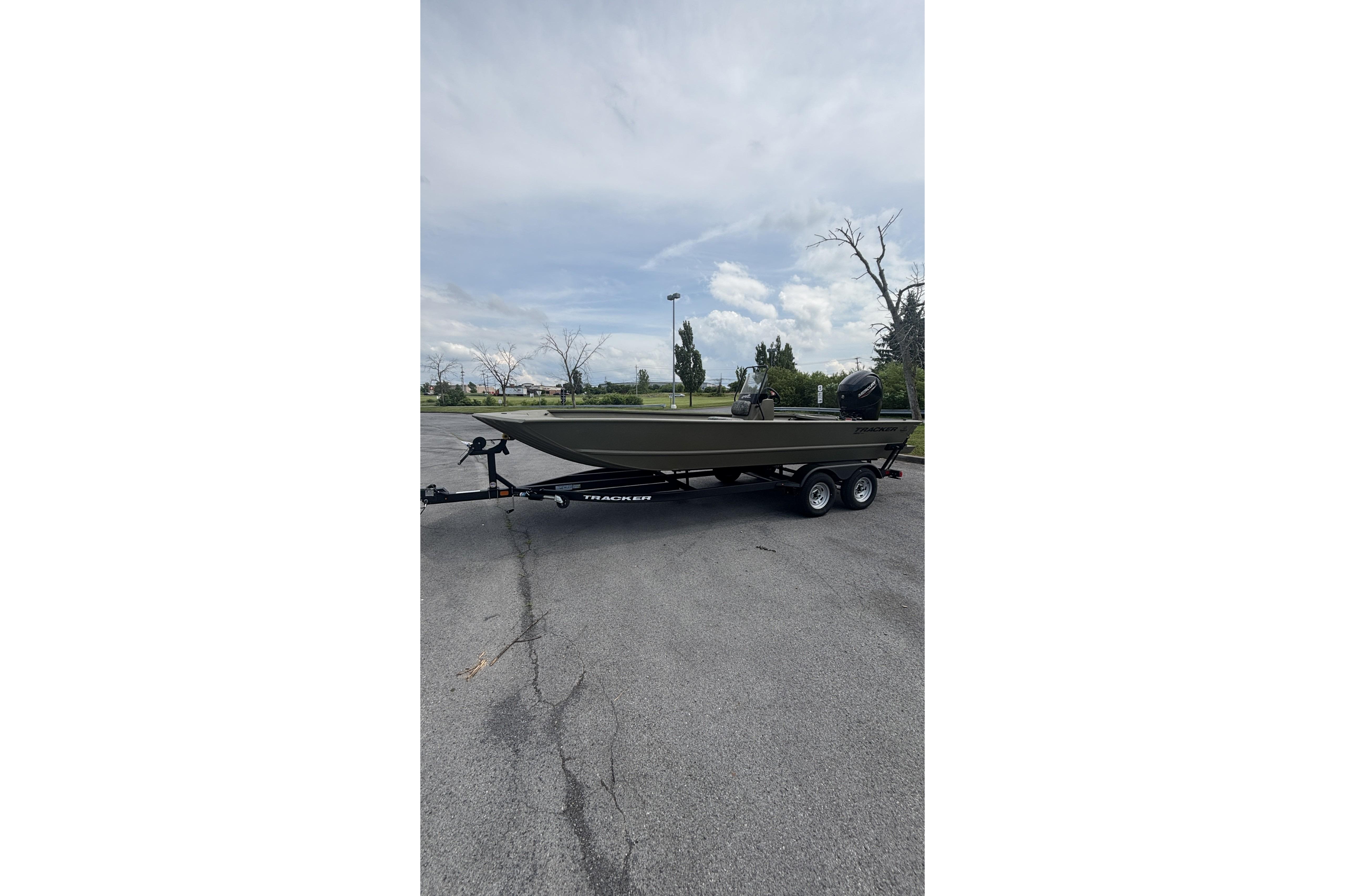 2026 Tracker Grizzly 2072 CC boat on trailer in parking lot.