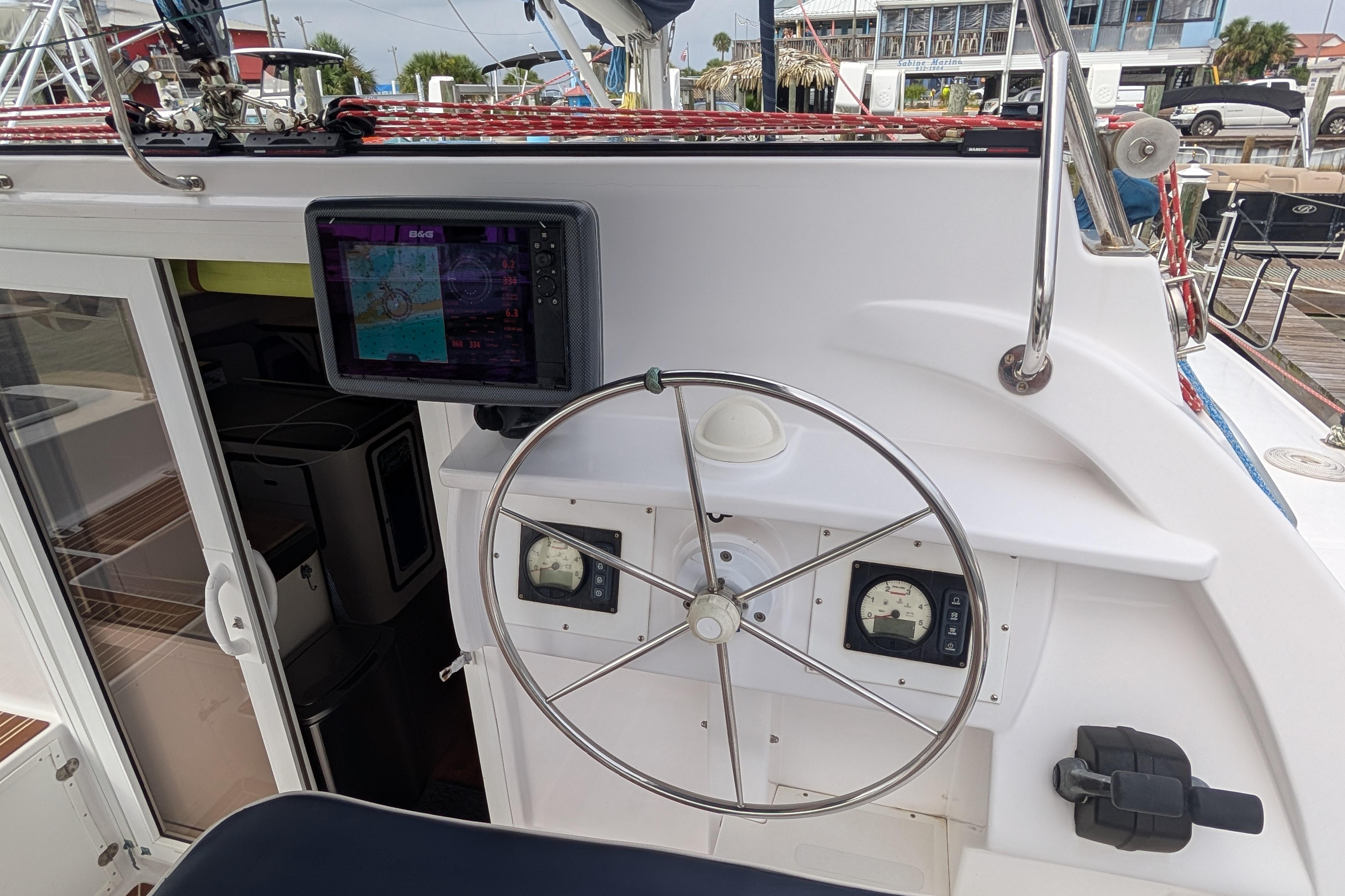 Cockpit of 1999 Island Spirit 37 sailboat with steering wheel and navigation equipment.