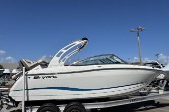 2019 Bryant Calandra 23 boat on trailer under clear blue sky.