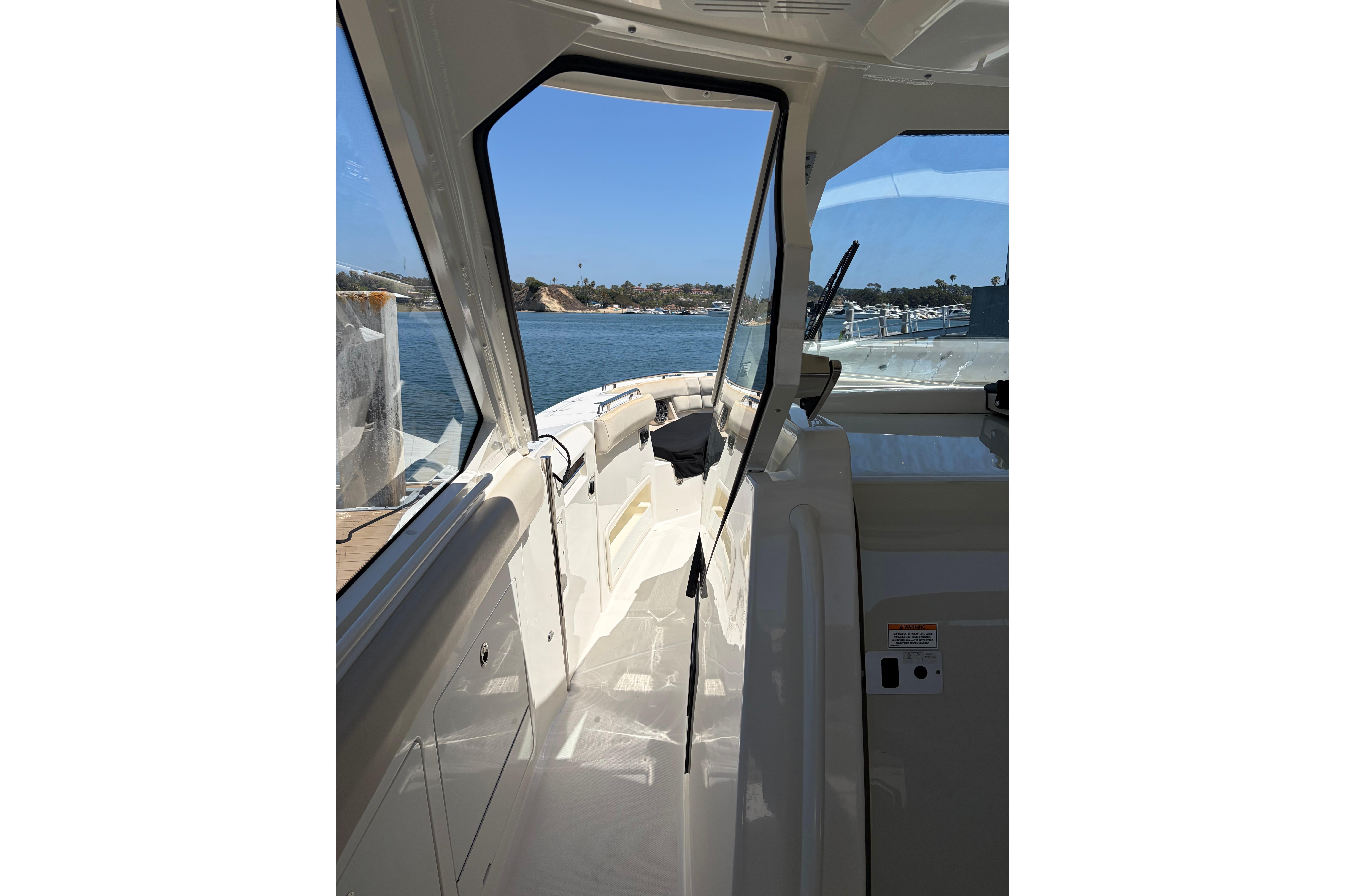 Interior view of a 2020 Boston Whaler 380 Realm boat with open cabin door.
