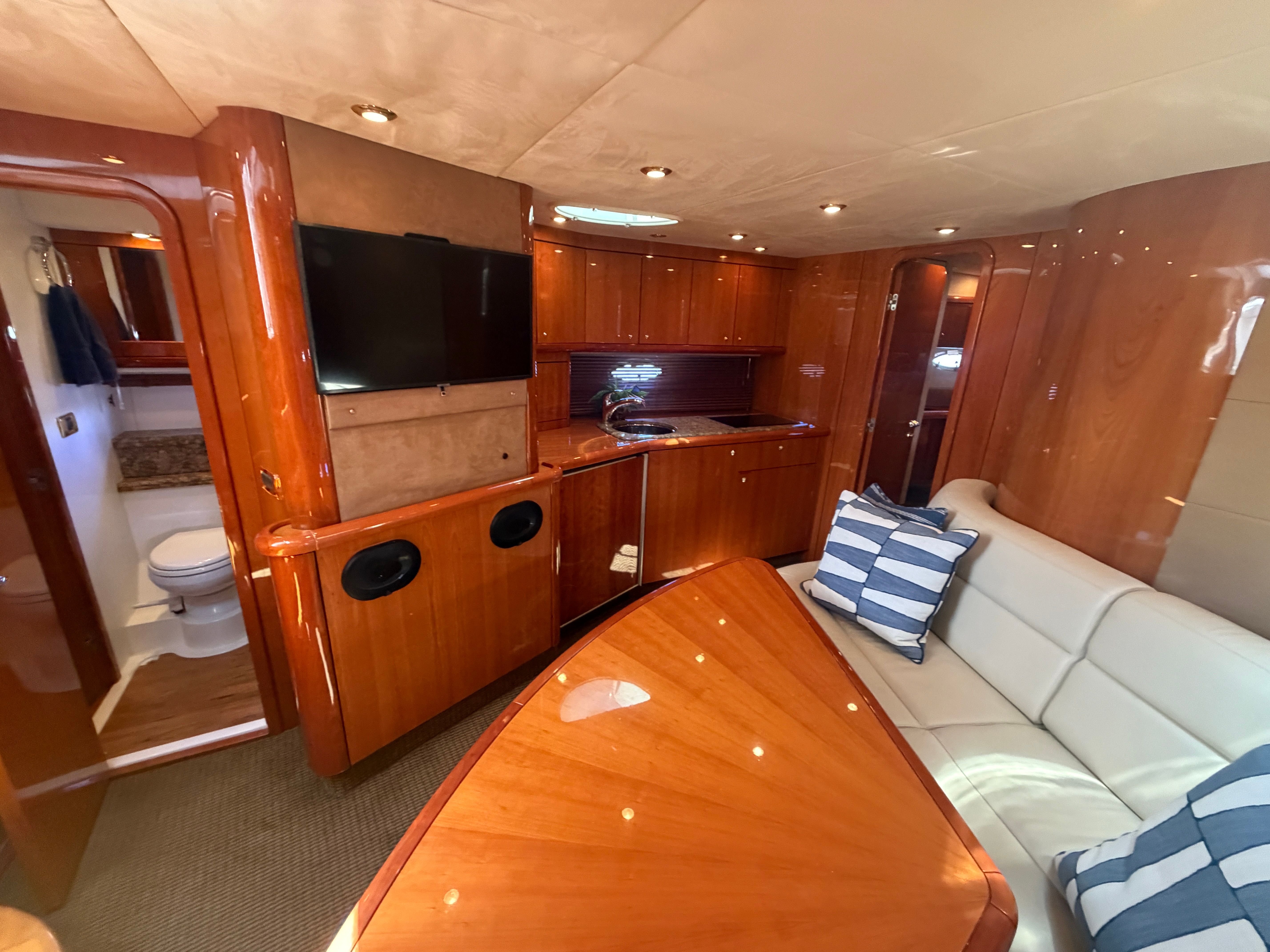 Interior of a Sunseeker Portofino 53 with elegant wood furnishings and comfortable seating.