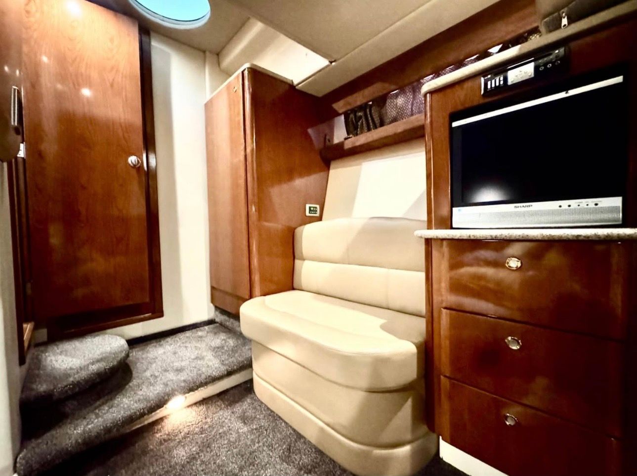 Interior of a 2007 Meridian 411 Sedan yacht with TV and seating area.