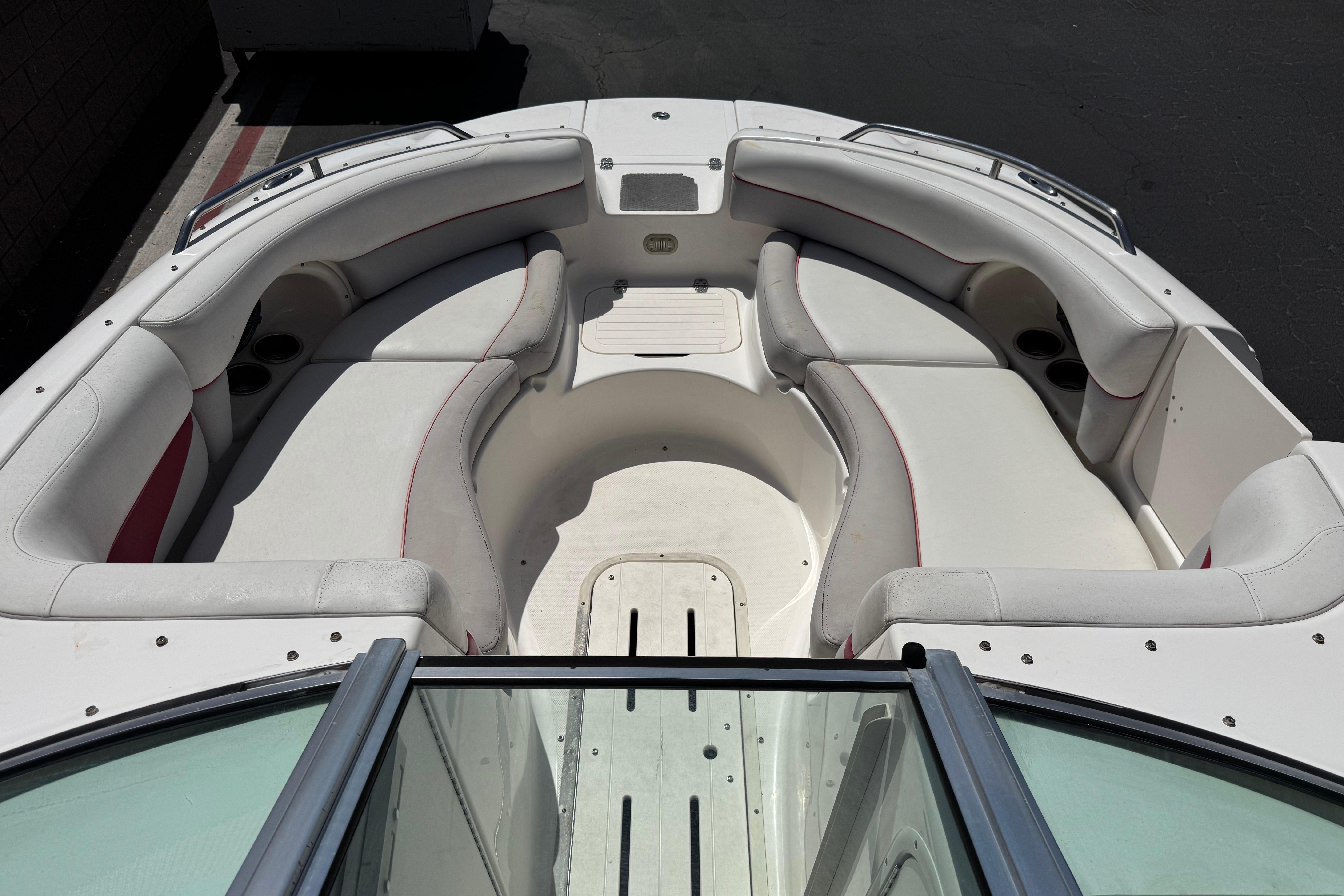 2010 Bryant 255 boat interior with white seating and cup holders.