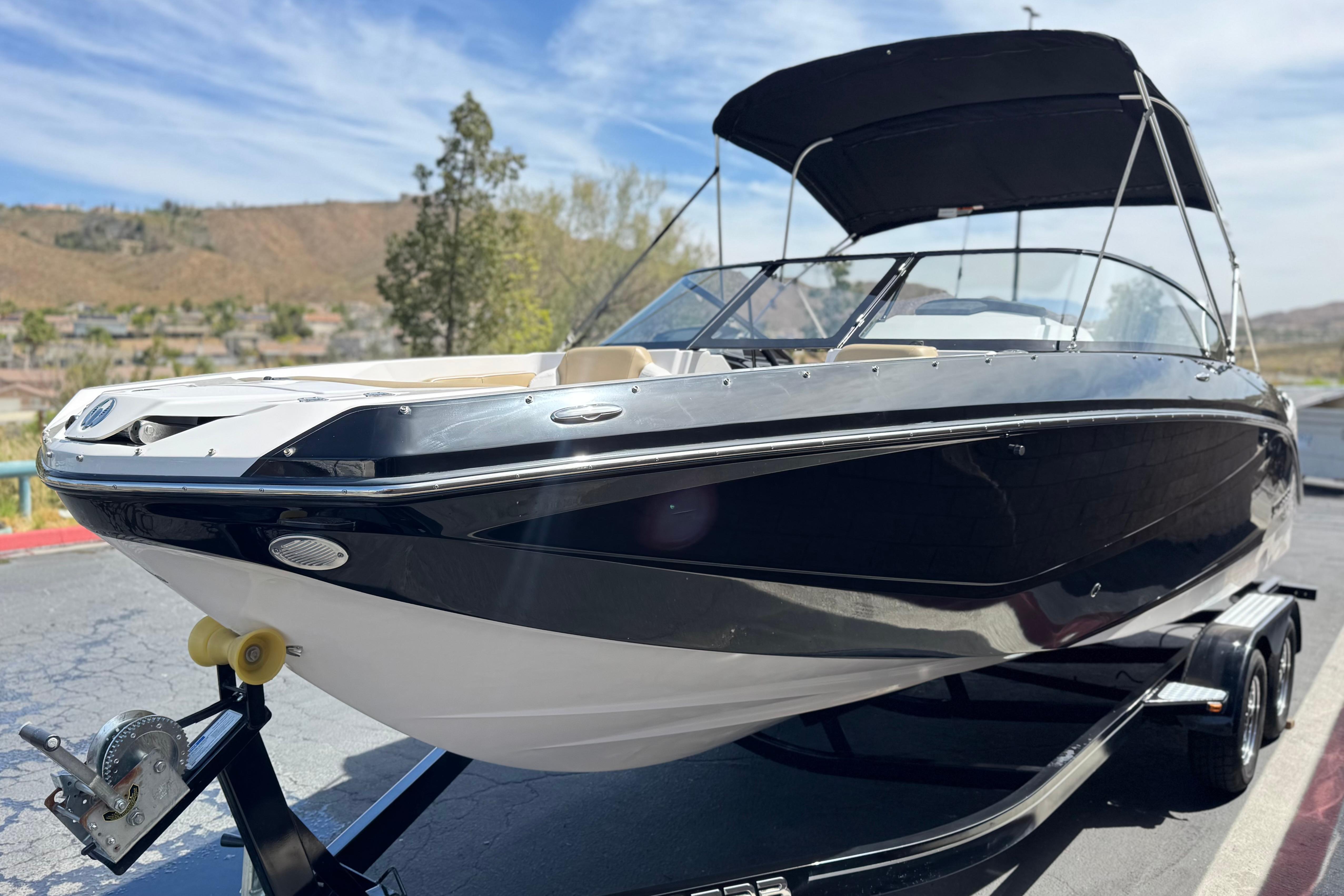 2017 Scarab 255 H.O. Platinum boat on trailer, black and white design, sunny day.