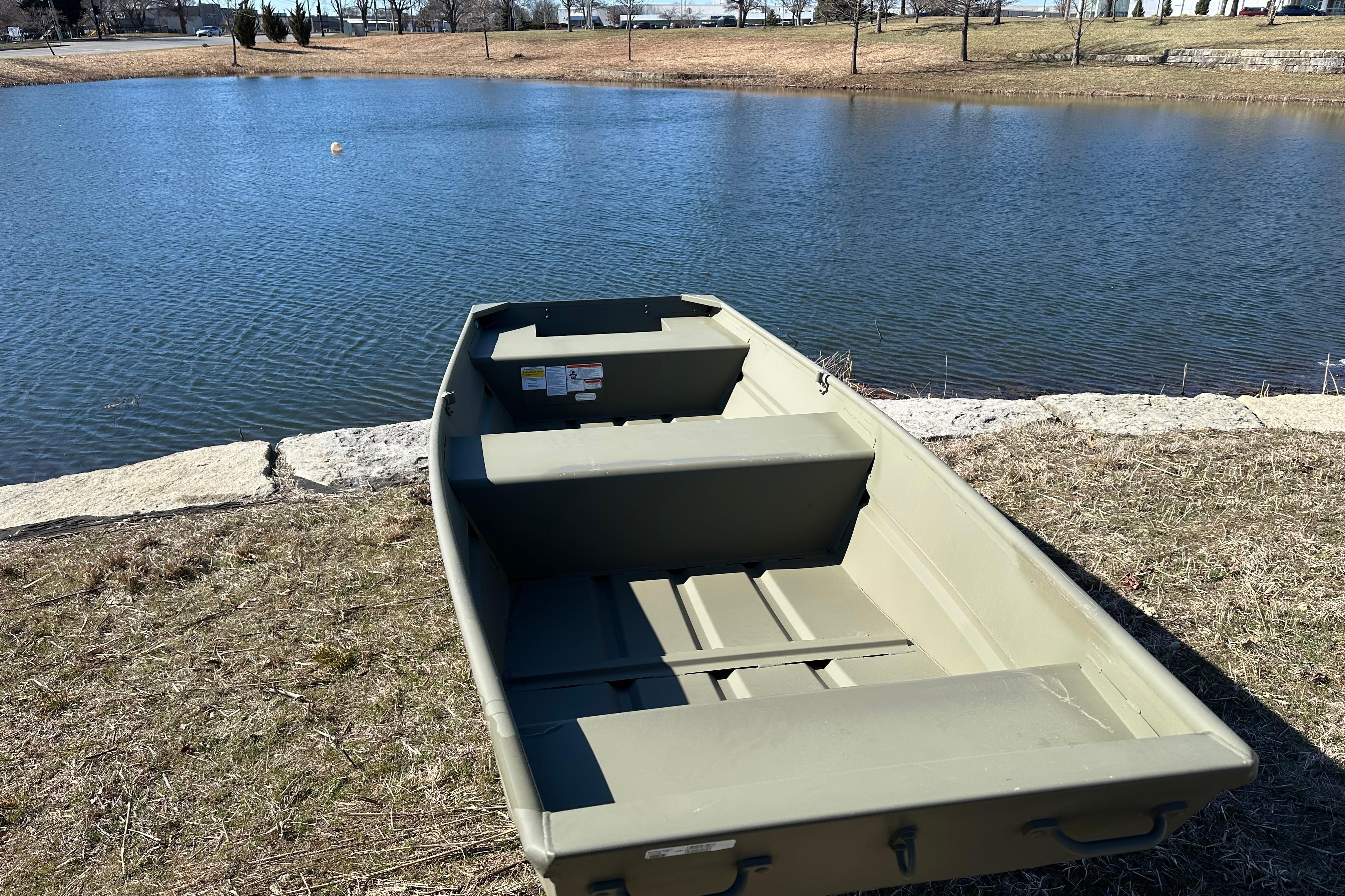 2026 Tracker Grizzly 14 Jon boat by a serene lake.