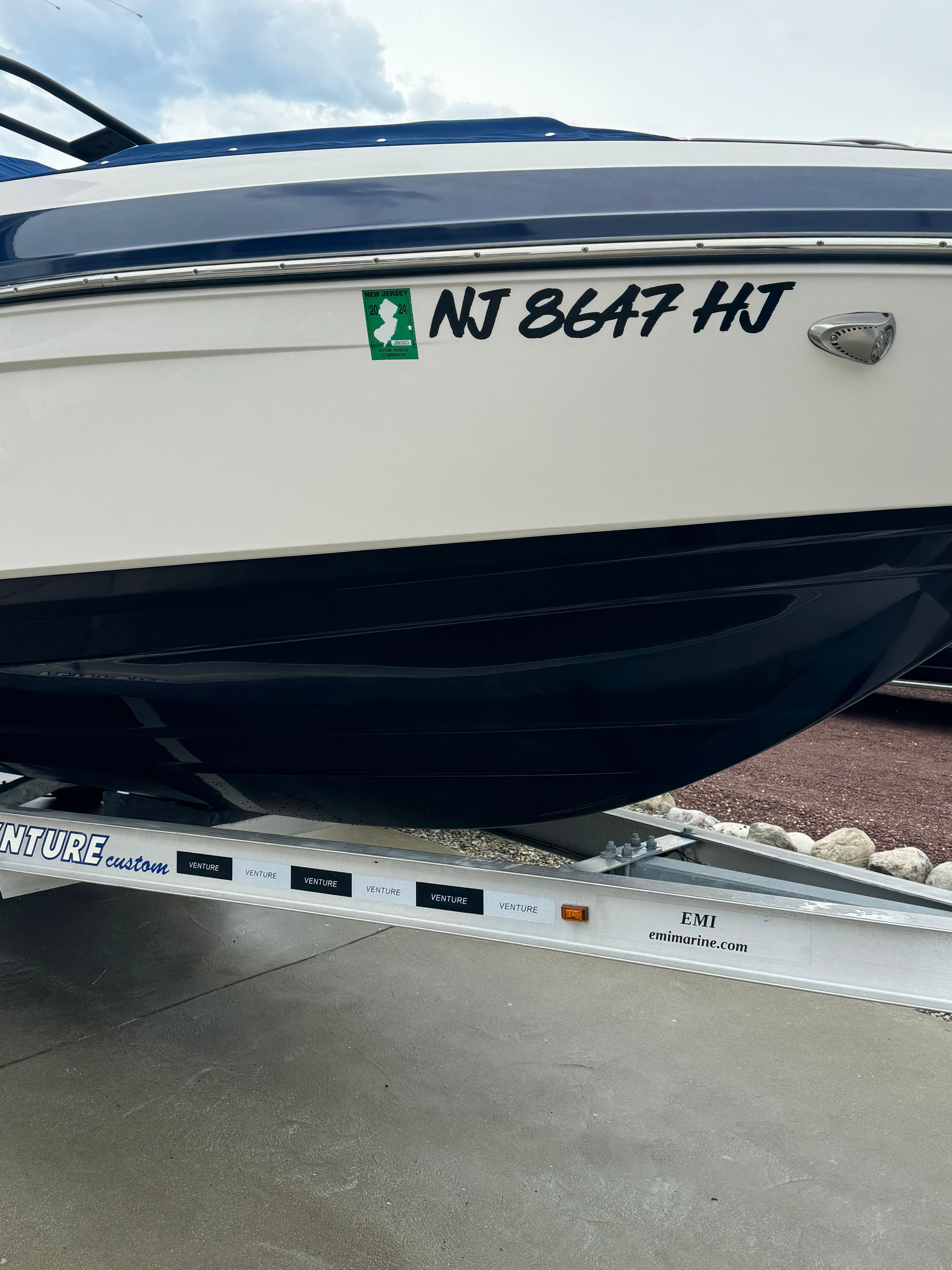 A 2016 Chaparral Vortex 243 VRX boat on a trailer, featuring a blue and white hull.