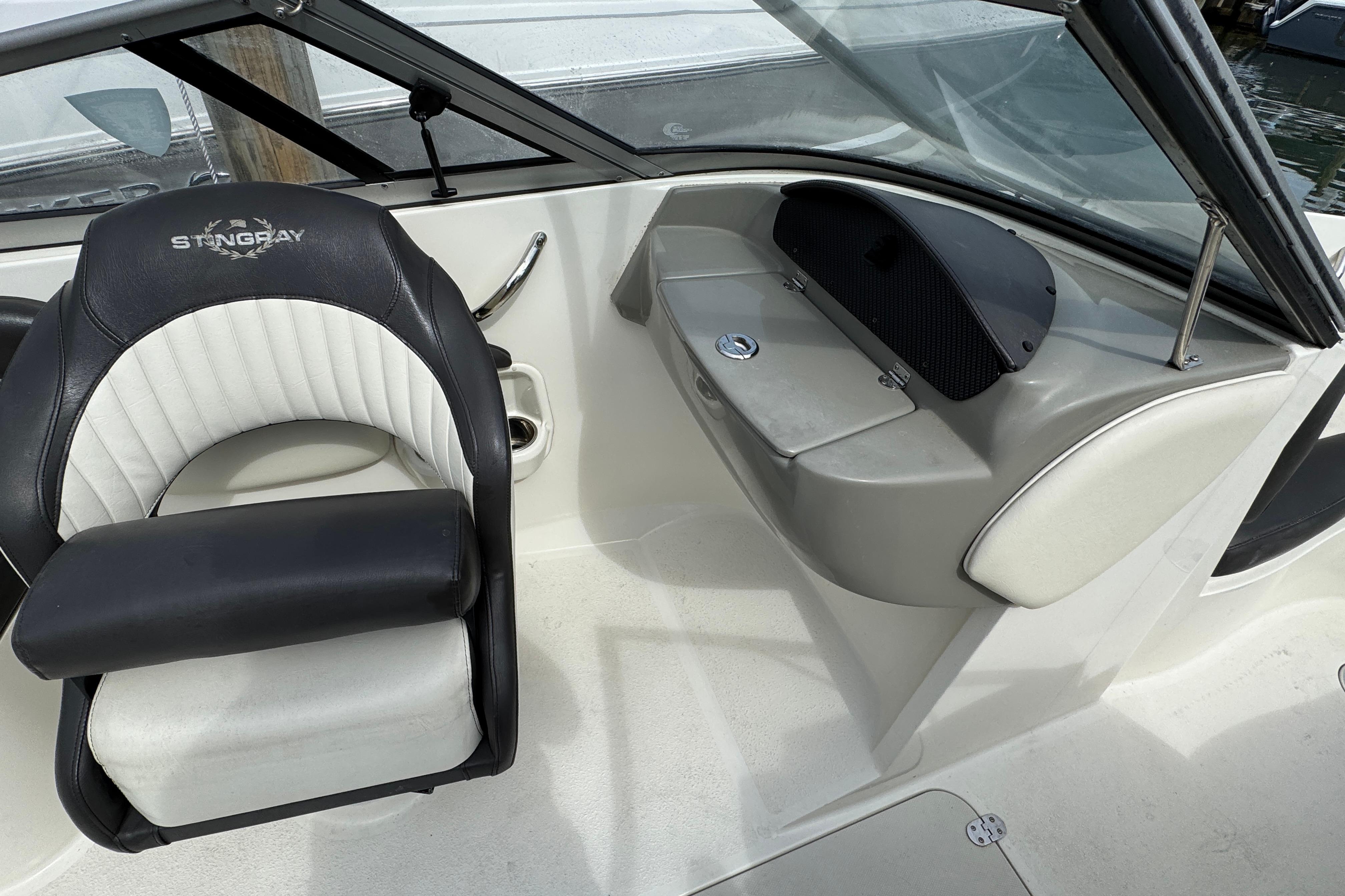 2018 Stingray 204 LR boat interior with black and white seating and dashboard.