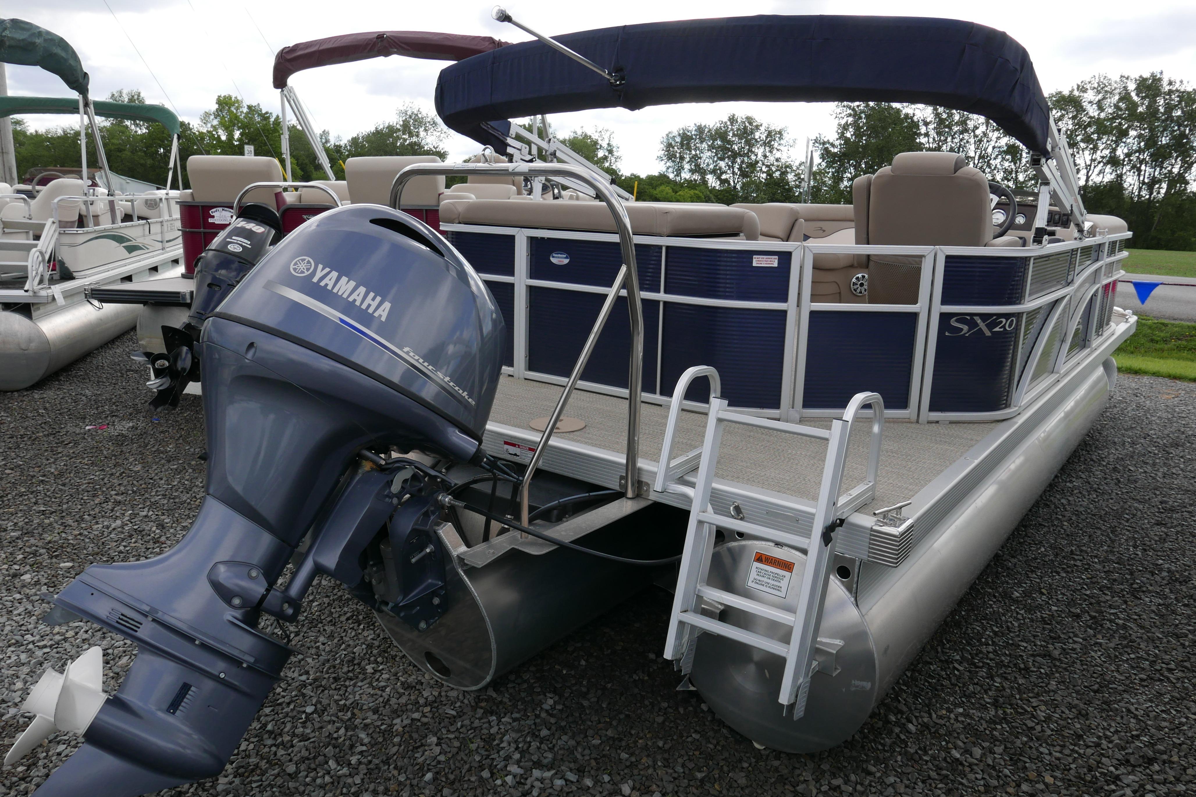 2019 Bennington SX 20 SLXP pontoon boat with Yamaha outboard motor on gravel.