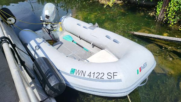 2014 AB Inflatables Lamina 10 boat docked in clear water.