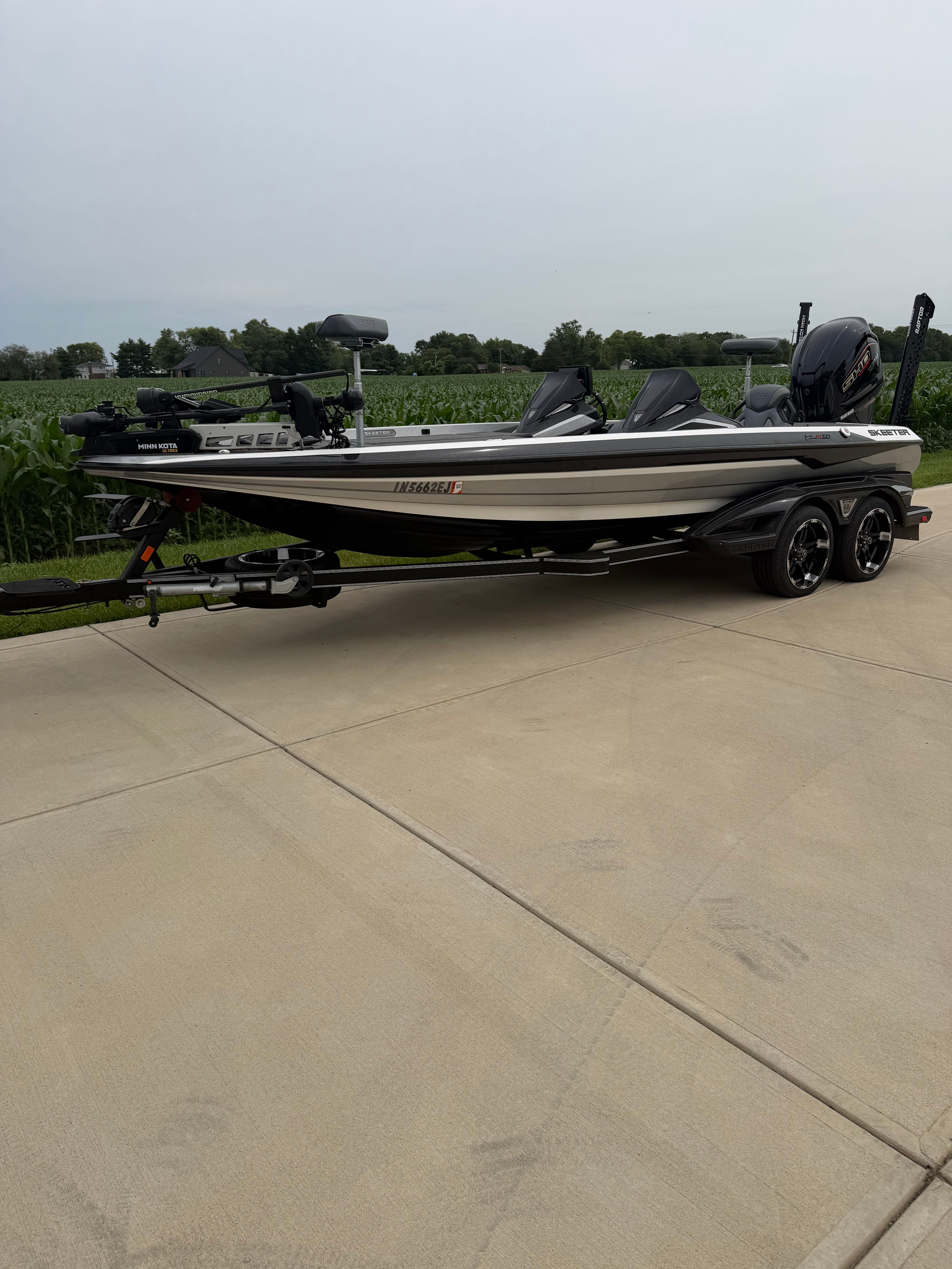 A 2022 Skeeter FXR21 Limited boat on a trailer, parked on a concrete surface.