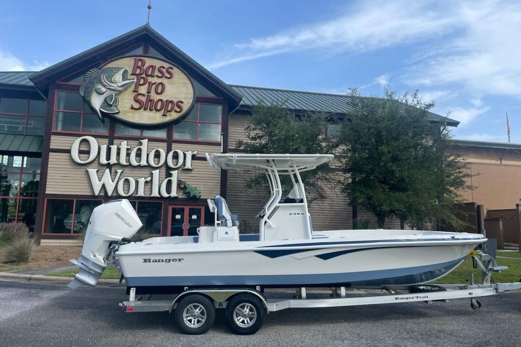 2025 Ranger 2360 Bay boat on trailer outside Bass Pro Shops Outdoor World.